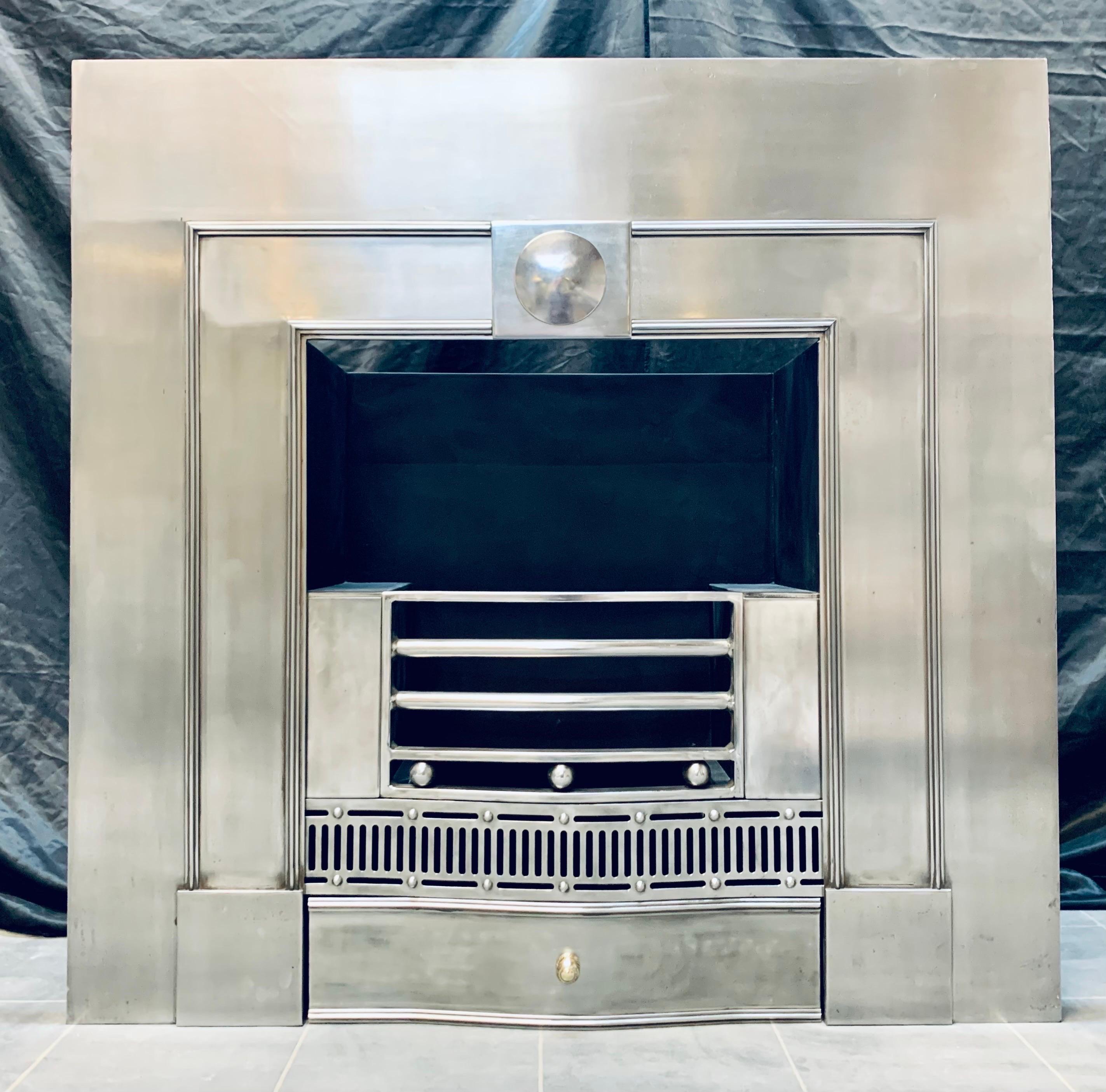 A 19th Century Georgian manner polished steel fireplace insert. A generous polished outer plate with an applied raised lambs tongue moulding, encompassing a central tablet with a projecting polished disc.
The four bared shaped fire front complete