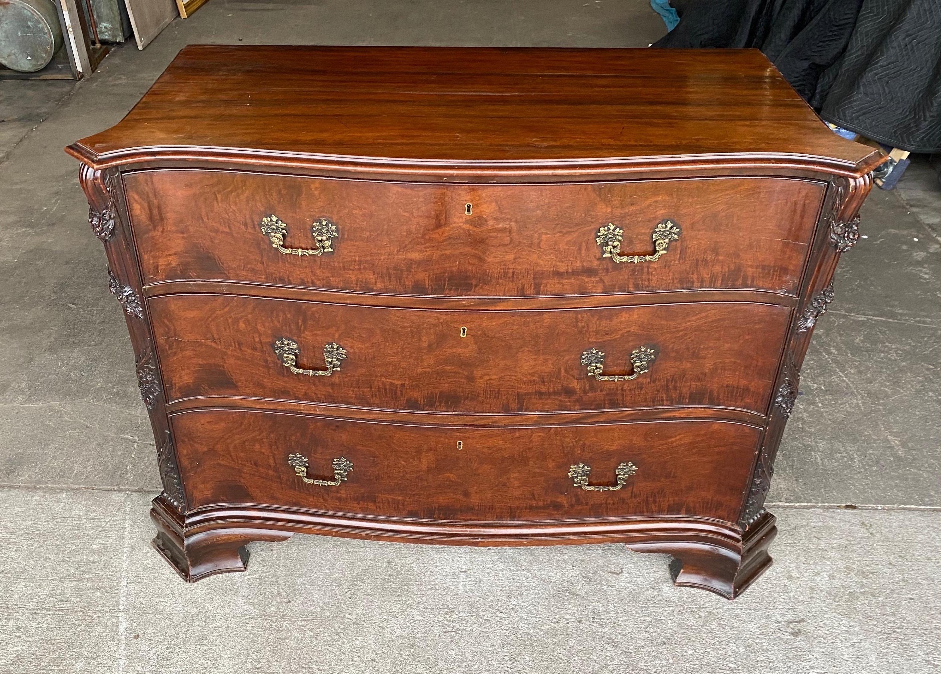 Great color and scale 19th century Georgian serpentine mahogany 3 drawer chest on ogee bracket feet with carved canted corners.