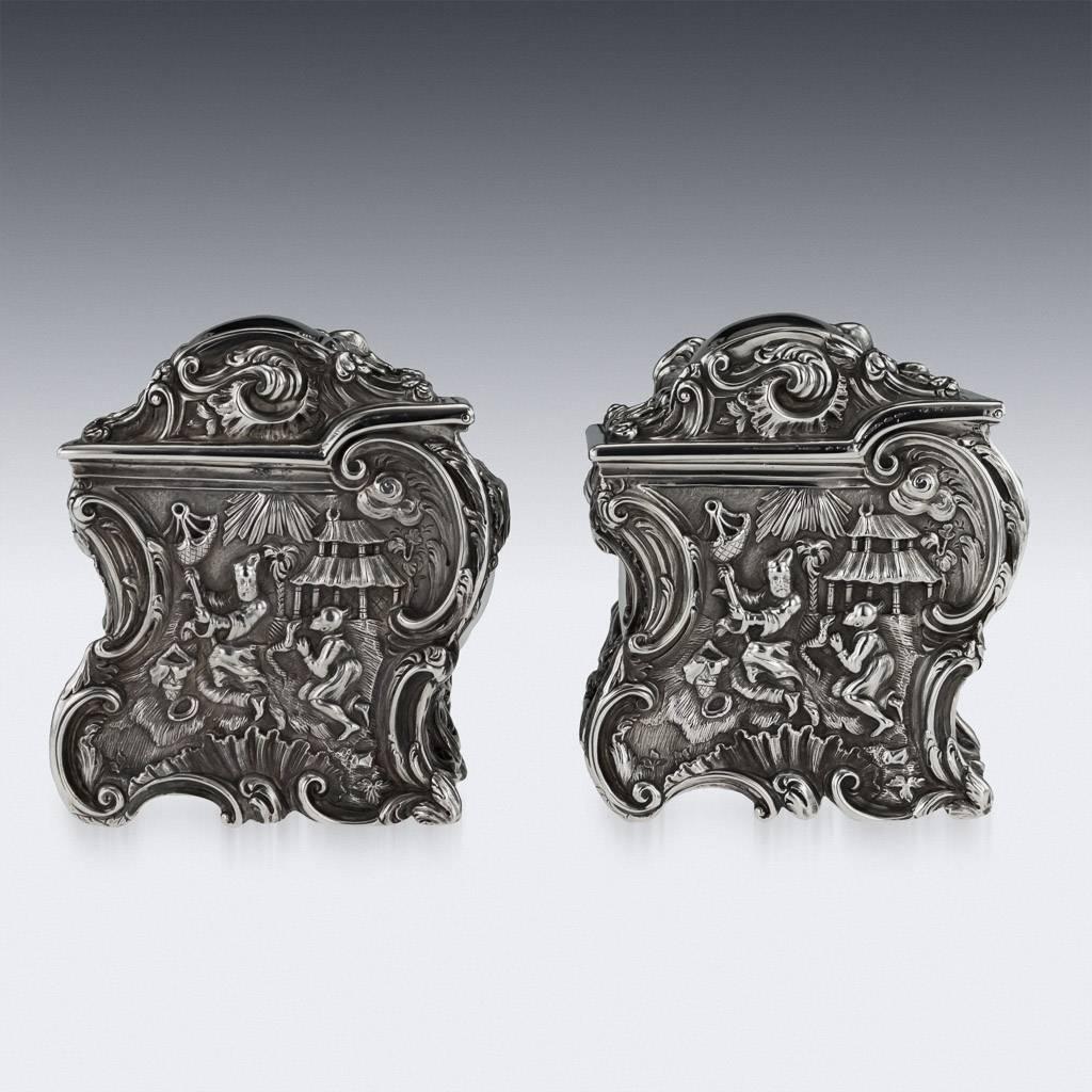 Antique 19th century Georgian exceptional rococo style solid silver pair of tea caddies, of rectangular form, profusely embossed in the chinoiserie style, the panels depicting c-scrolls and flowers surrounding Chinese figures, lions and pagodas,