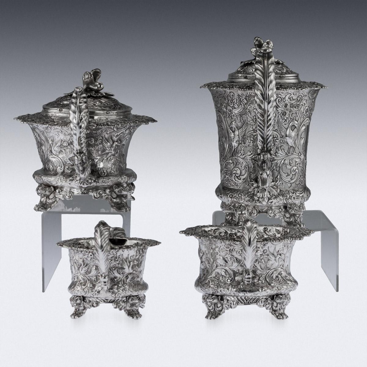 Antique 19th century Georgian / Victorian solid silver four-piece tea and coffee set, comprising of a coffee pot, tea pot, sugar bowl and cream jug, each elaborately chased body resting on four cast leaf feet mounted with foxes heads, the body