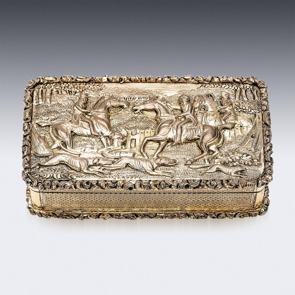 Antique 19th Georgian solid silver-gilt large snuff box, impressive size and heavy gauge, cover chased in high relief depicting a hunting scene, with a pronounced floral boarders to both sides and engine turned decoration. Hallmarked English silver