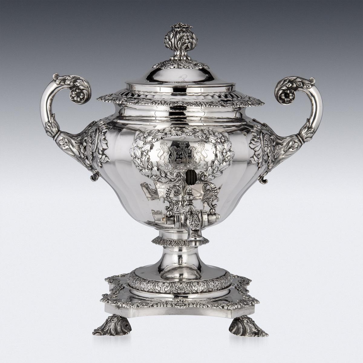 19th Century Georgian silver hot water samovar, inverted pear shaped on a shaped square base, cast scroll feet, body profusely chased in relief with flowers, scrolls and acanthus leaves, applied with large twin leaf caped c-shaped handles, a hot