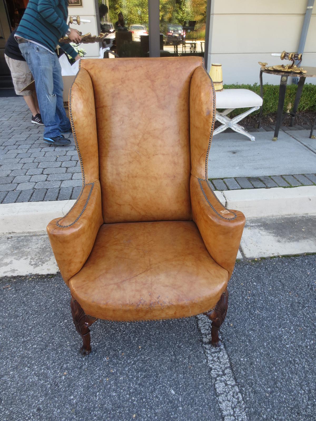 19th century English Georgian style wing chair in leather with well carved walnut cabriole legs and shell motif.
26.75