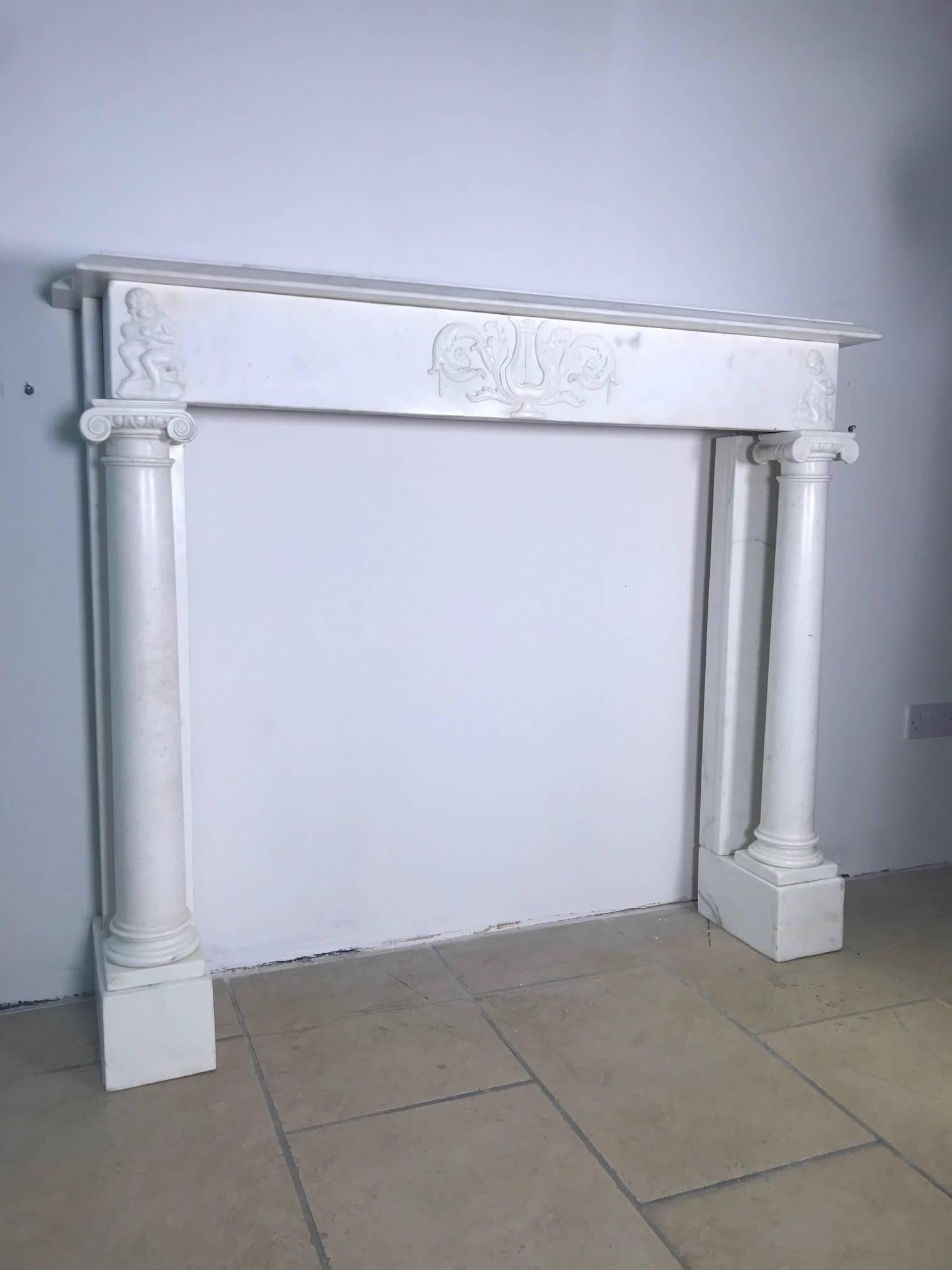 A very rare Georgian white statuary marble mantelpiece,
circa 1810-1830. This untouched and important fireplace was salvaged from a
London Mayfair town house.
This musically influenced chimney-piece is delicately hand carved, with its frieze