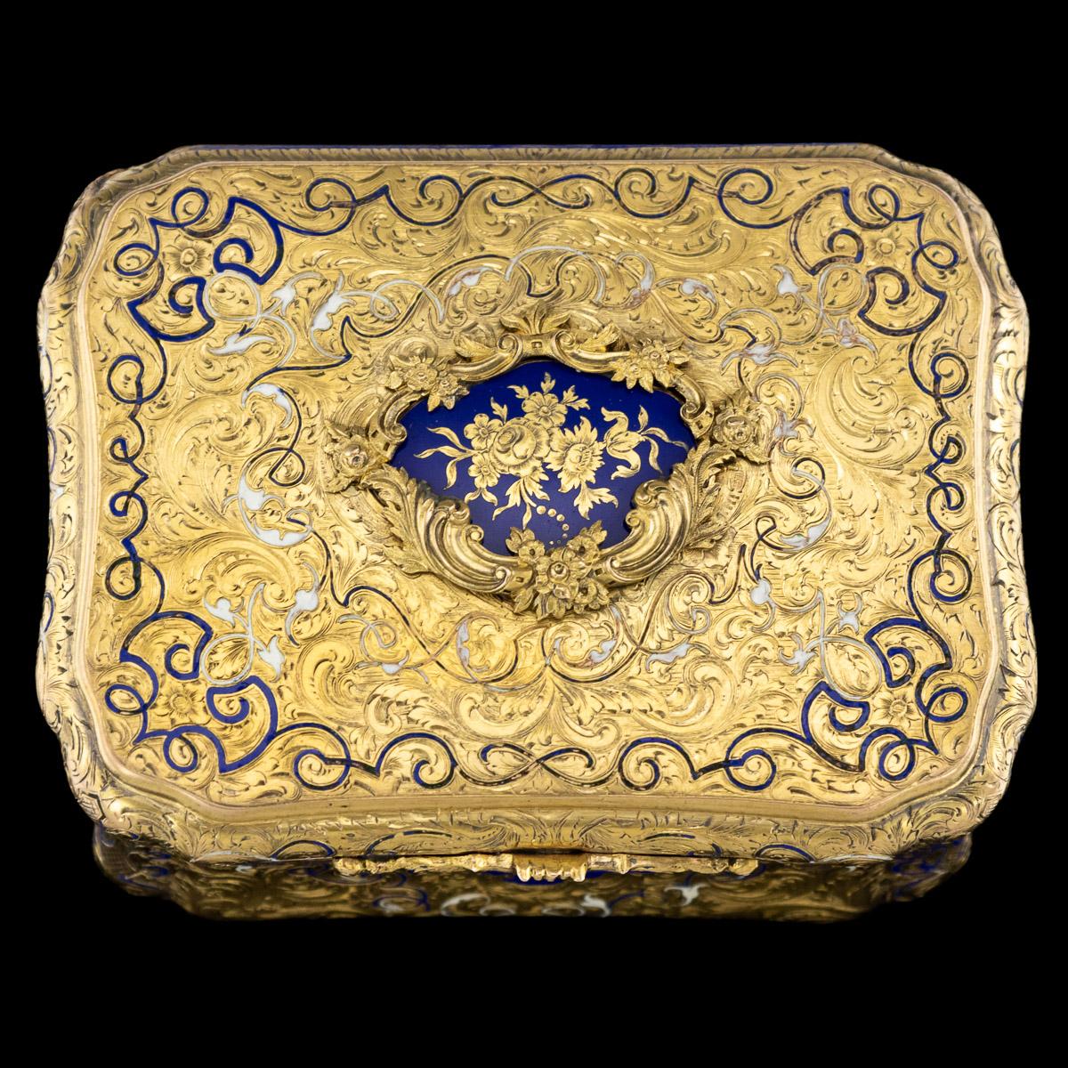 Antique mid-19th century German 14-karat solid gold snuff box, particularly large and of rectangular bombe shape, decorated with champlevé white and blue enamel tendrils, profusely engraved with scrolled foliage and flowers on reeded ground, the