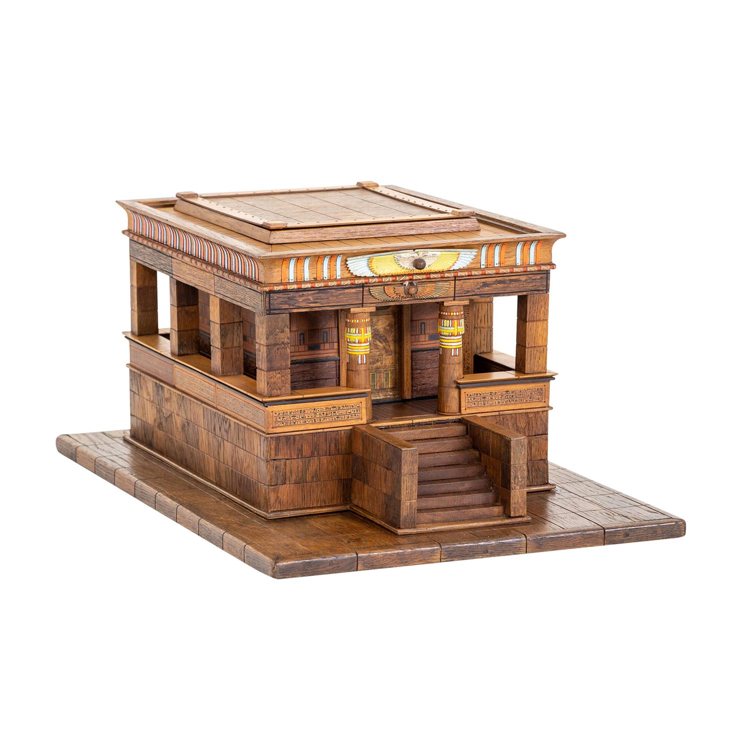 A light-brown, antique German model of an Egyptian temple made of handcrafted, partly painted Mahogany and Walnut, in good condition. The inside of the detailed décor piece is composed with a grave and hidden, secret compartment storage which is
