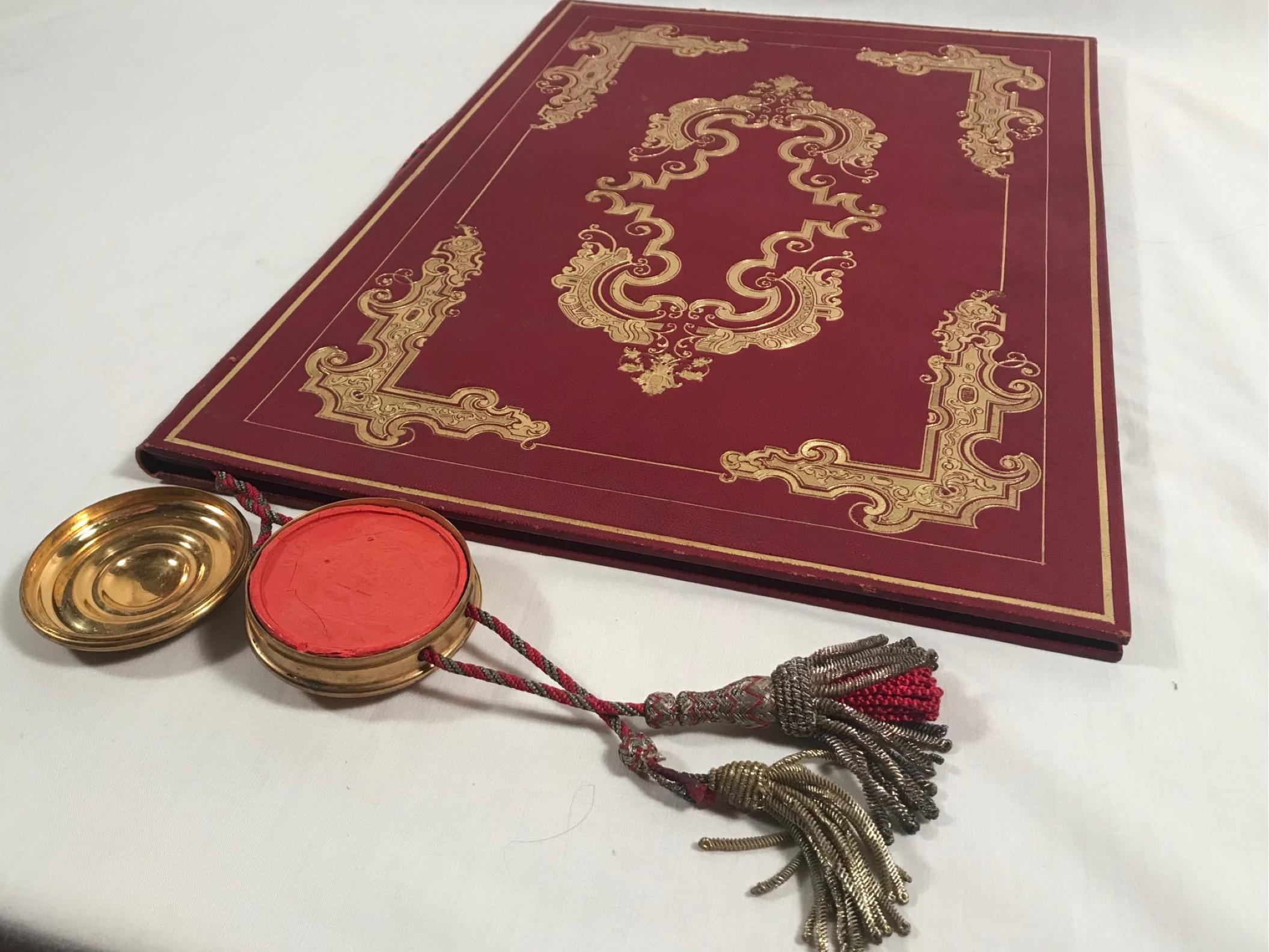 19th century German Baronship Document, Archduke Ludwig III of Hessen

Outstanding document bound with threaded rope in crimson red leather with burnished 24-carat gold embossed. A wax seal of the Arch Dukedom enclosed in a brass box with gold