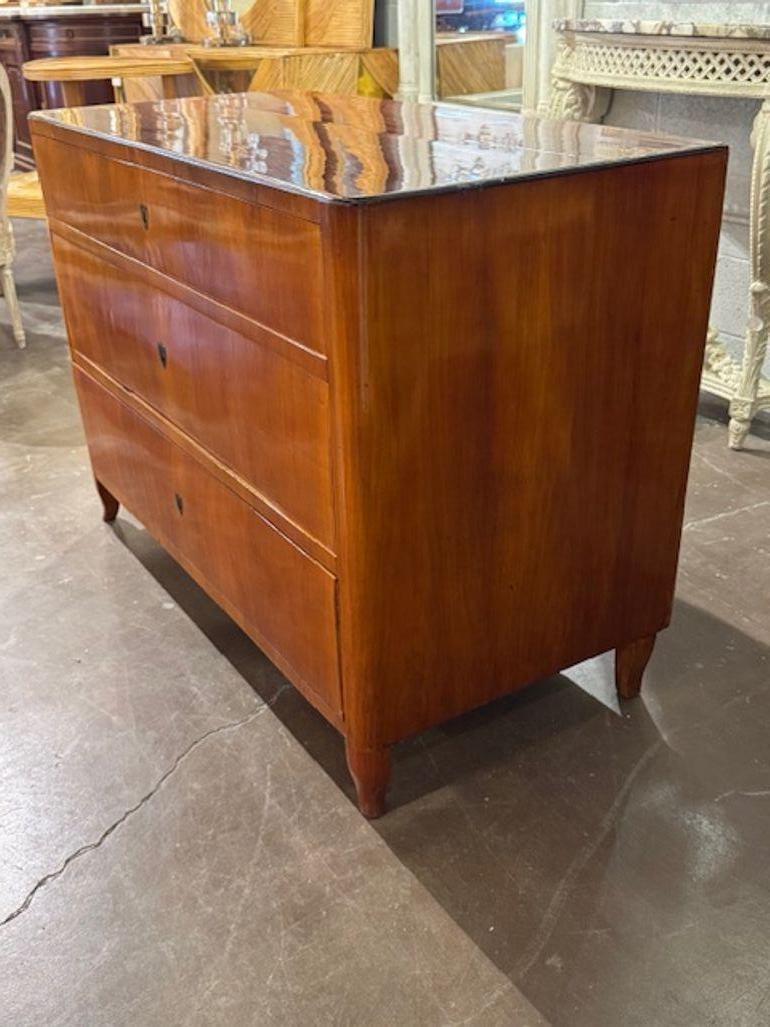 This 19th century walnut German Biedermeier commode is a stunning antique piece of furniture. Made from high-quality walnut, with a hand shellac finish  it exudes elegance and sophistication with its classic design. Perfect for adding a touch of 