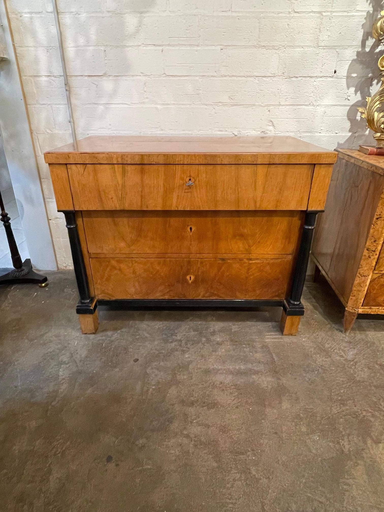 Very fine flame mahogany Biedermeier commode with ebonized details. The piece opens up to reveal drawers for storage. And the finish on this piece is exceptional. Stunning!!