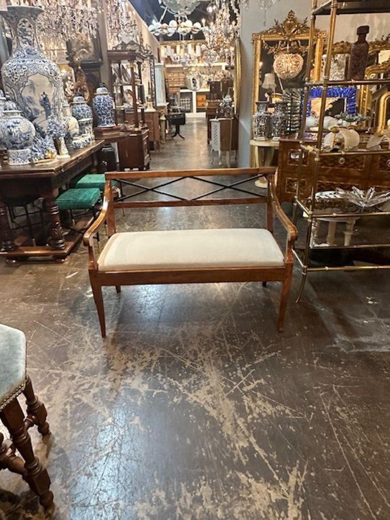 Handsome pair of 19th century walnut settees with ebonized details from Germany. Upholstered in a creme colored fabric. Beautiful, polished wood and nice clean lines. Gorgeous! Note: Price listed is for 1