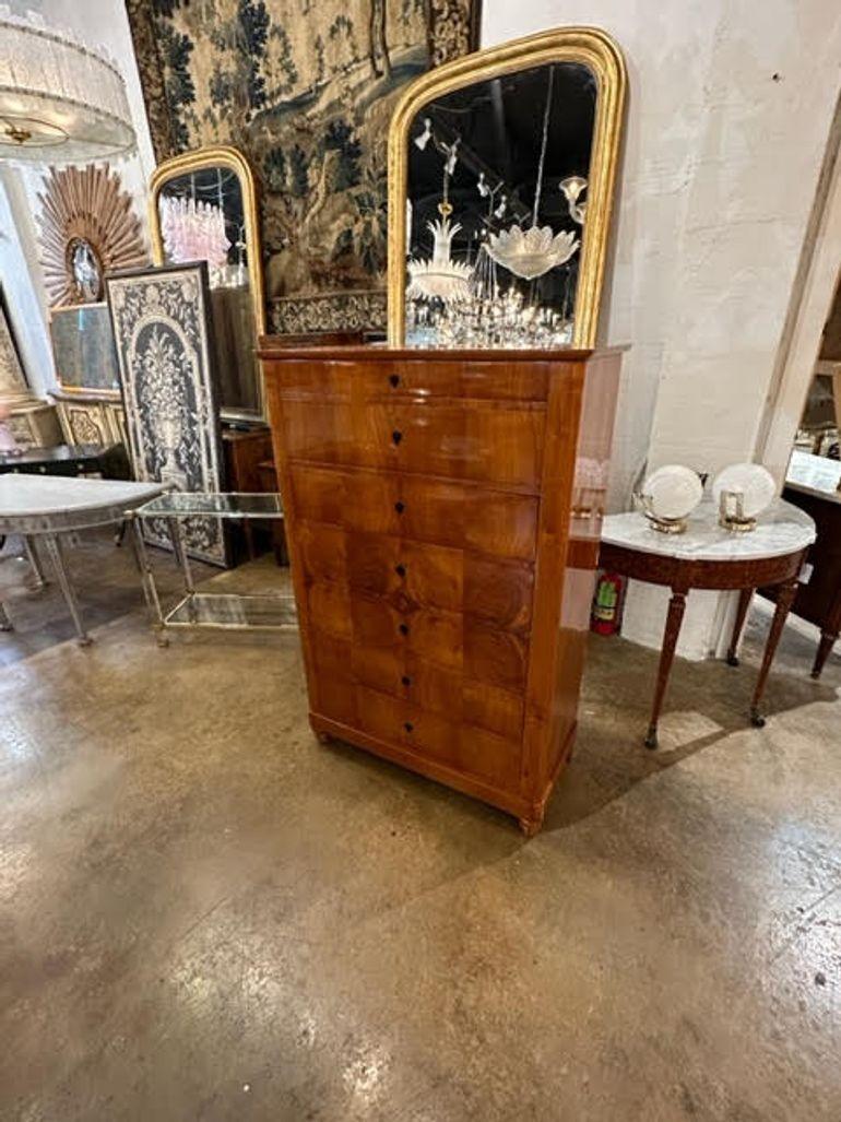 Exceptional 19th century German Biedermeier tall cherrywood chest of drawers. Very fine quality and gorgeous wood grain. A very fine piece that is sure to impress!