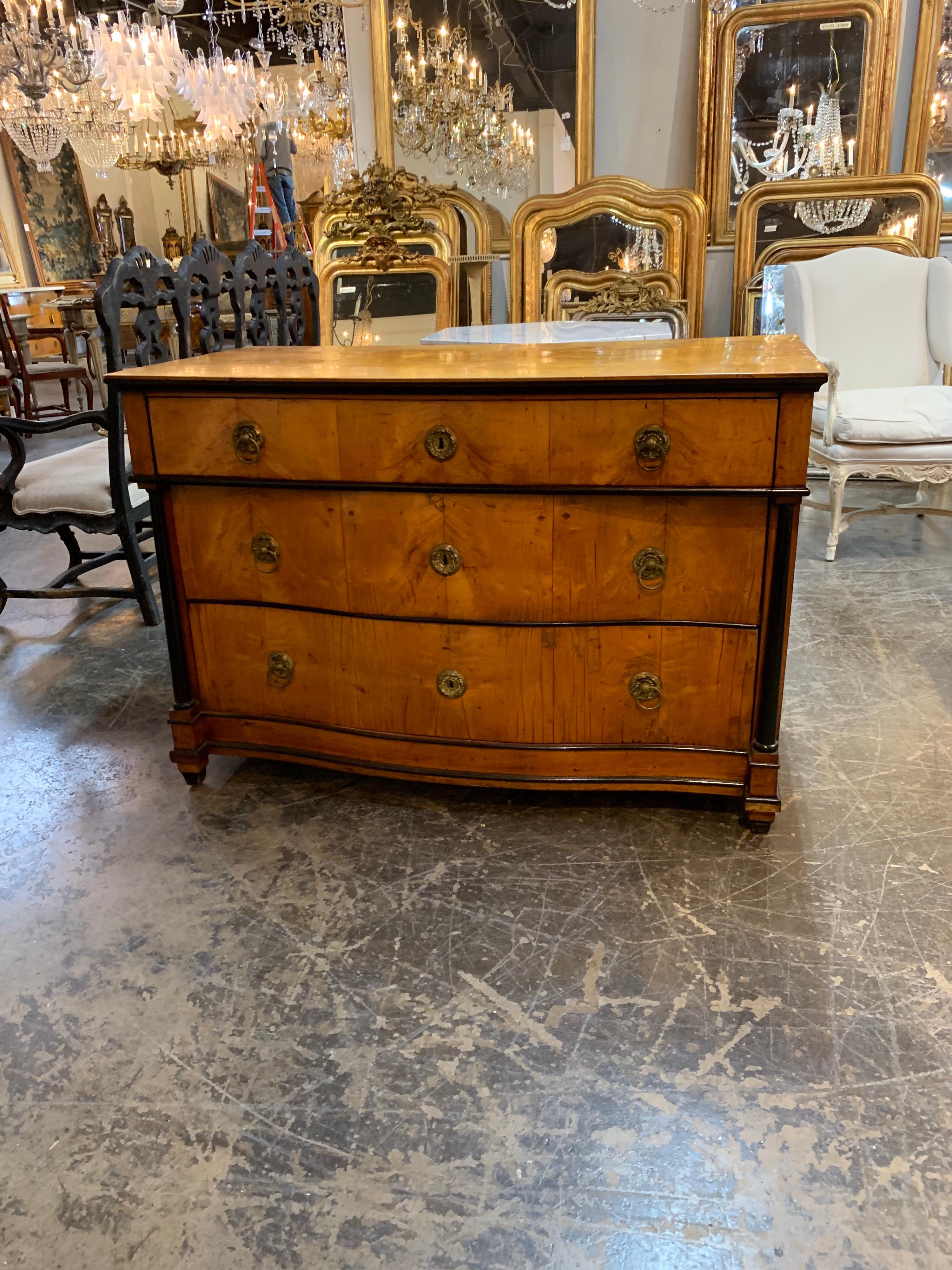 Very handsome German 19th century Biedermeier walnut commode. The piece has nice ebonized details and a beautiful finish. Ample storage as well!