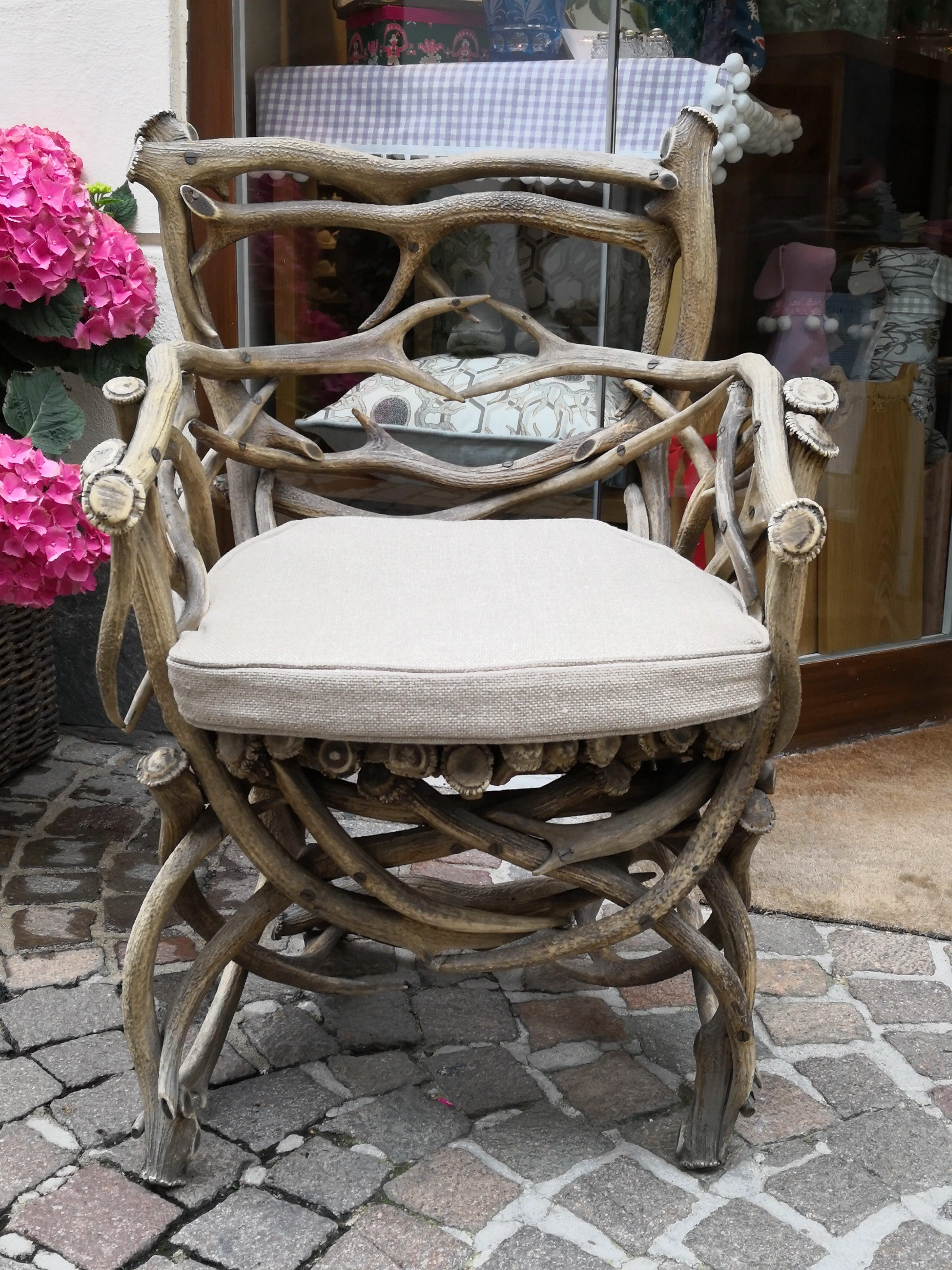 19th century German antler trophy armchair completely handcrafted from a large range of antler trophies with armrests in the style of Black Forest. This armchair is part from a German hunting salon interieur. Dated 1892 in the Horn. A made by