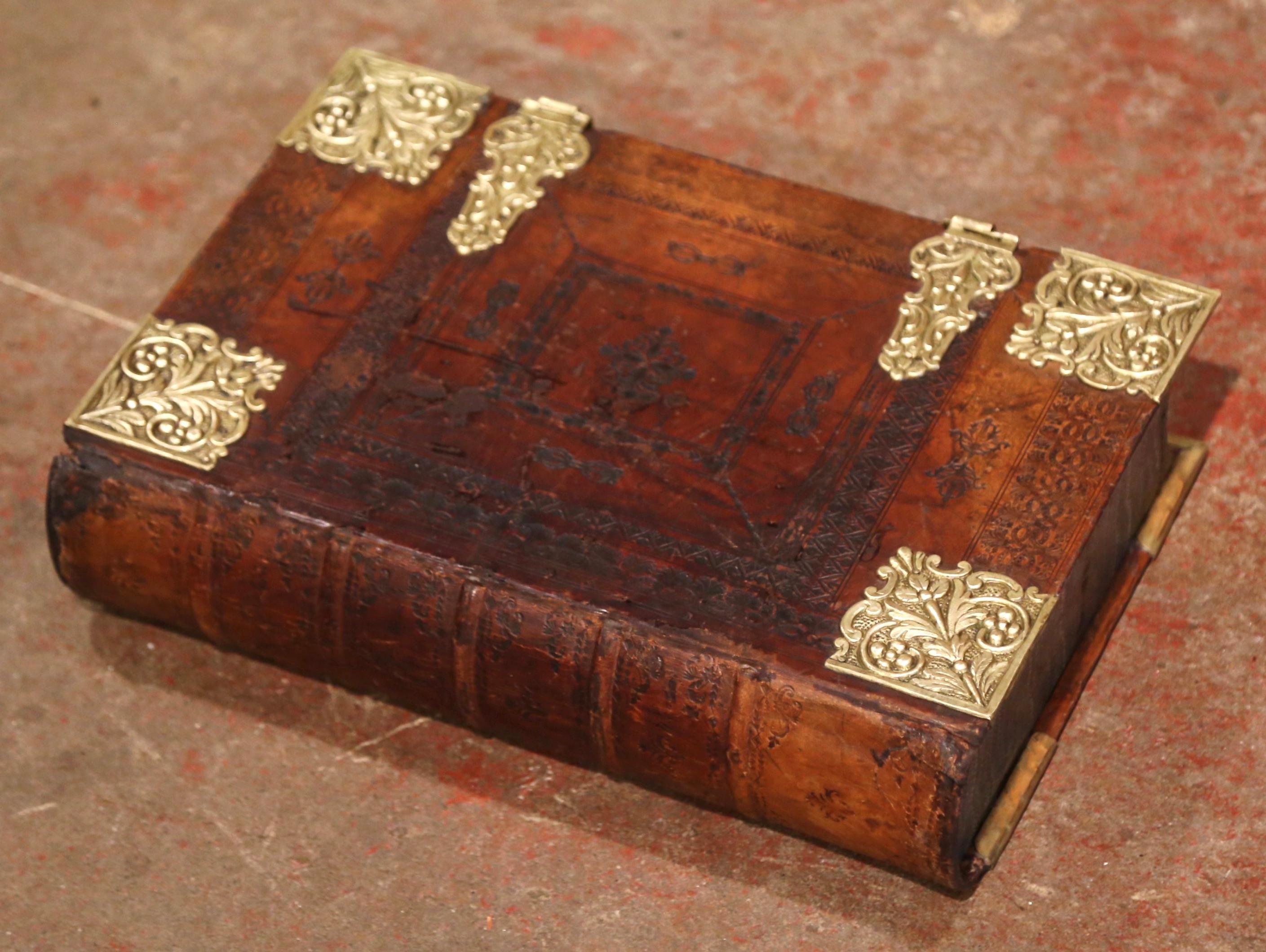 Store your TV remote controls or other valuables in this antique “Trompe l’œil” box. Created in Germany circa 1880, the embossed leather book binding, now fashioned as a table box is fitted with gilt brass clasps and corner mounts. It has marbleized