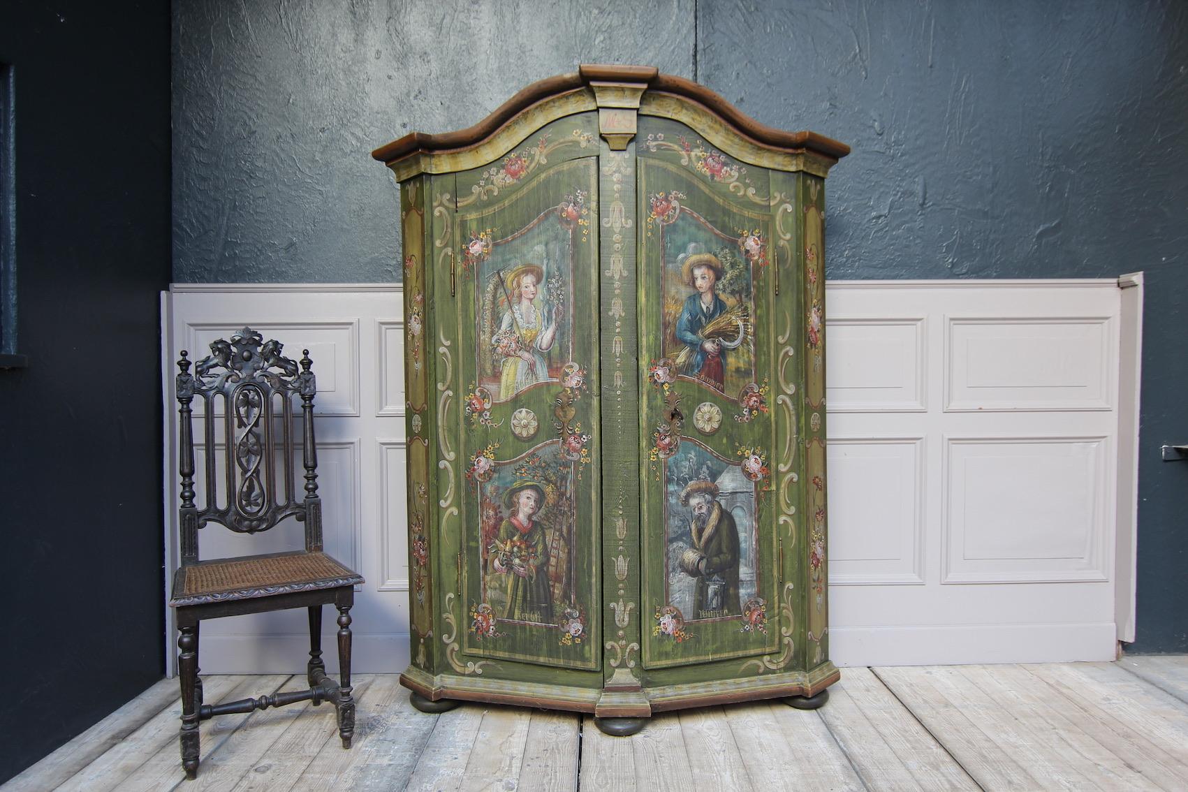 19th century German hand painted provincial cabinet made of pine. Painting with motifs of the 4 seasons.
2-door body with beveled corners, standing on pressed ball feet, dividable in the middle with wooden wedges.
Header with round arch and