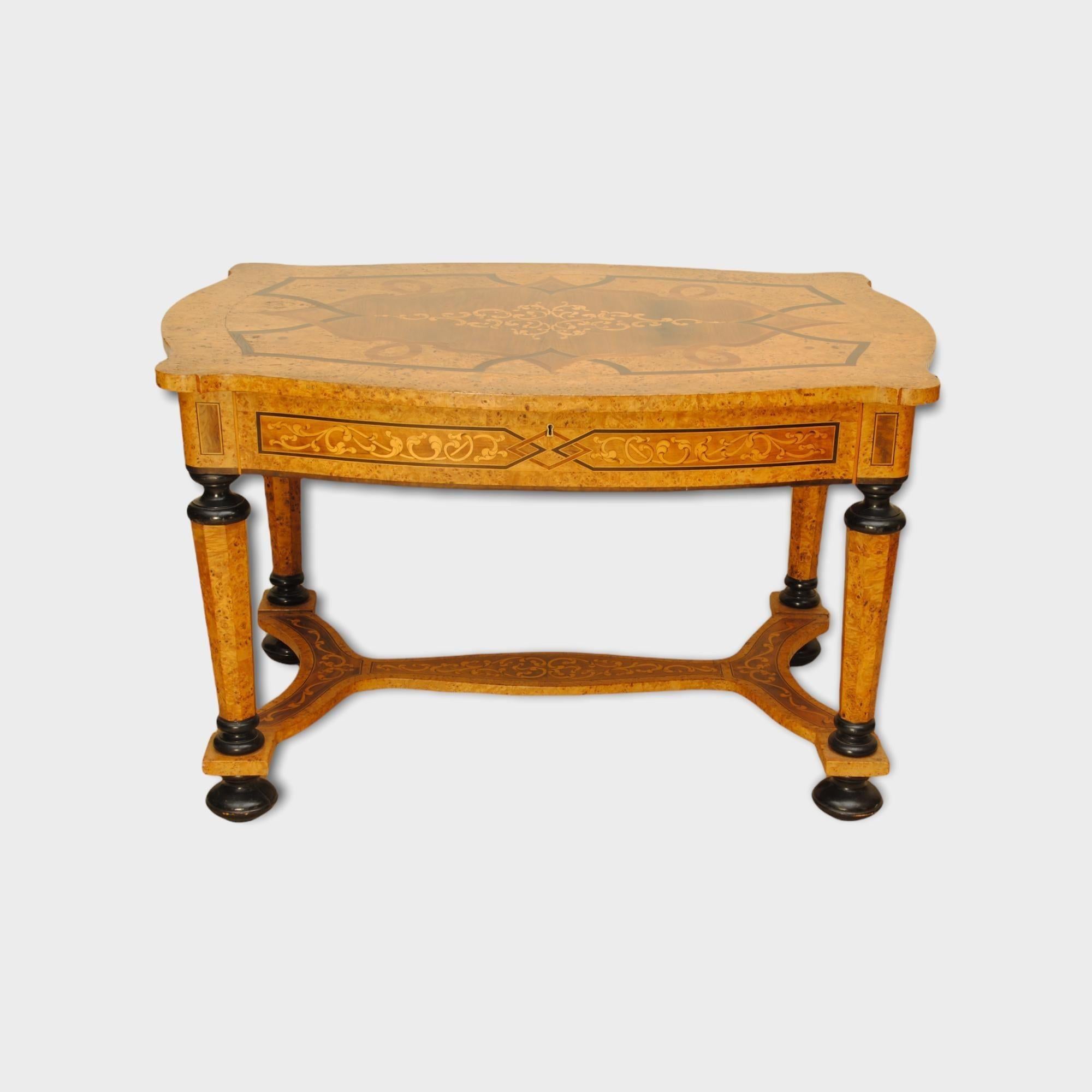A 19th century German burr field maple marquetry inlaid table of lovely colour and decoration, with a drawer to the front frieze. The whole inlaid with flowing floral design and the top with geometric inlays.