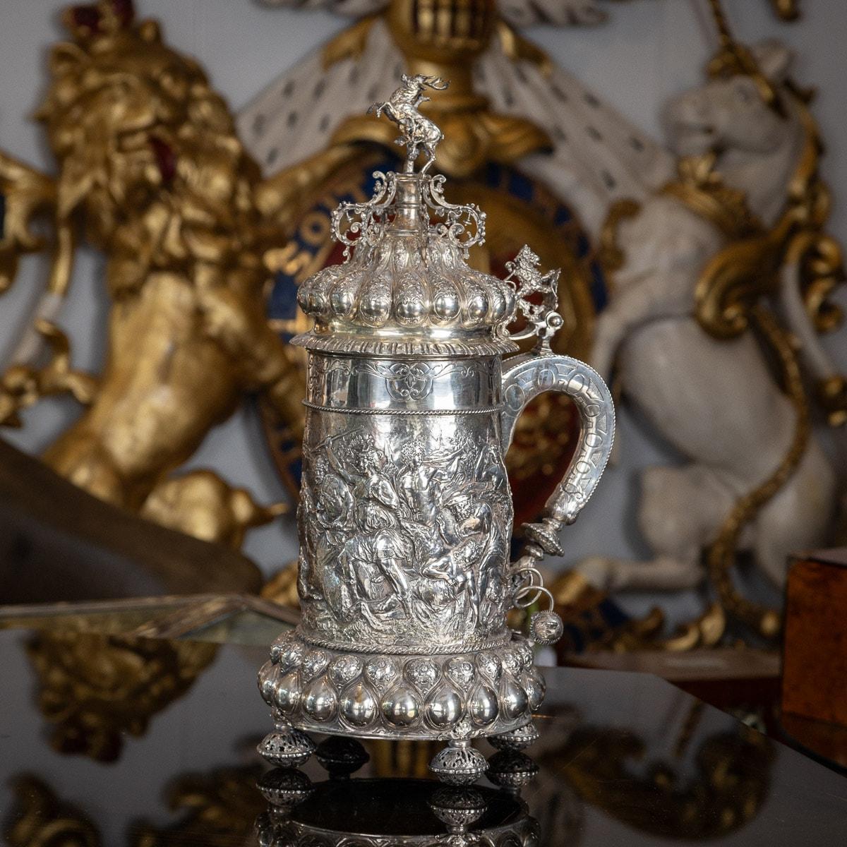 Antique 19th Century Monumental German solid silver lidded tankard, in the style of the early 17th century examples, beautifully chased and embossed with a very detailed and crowded boar and stag hunting scene, depicting Diana the huntress. The