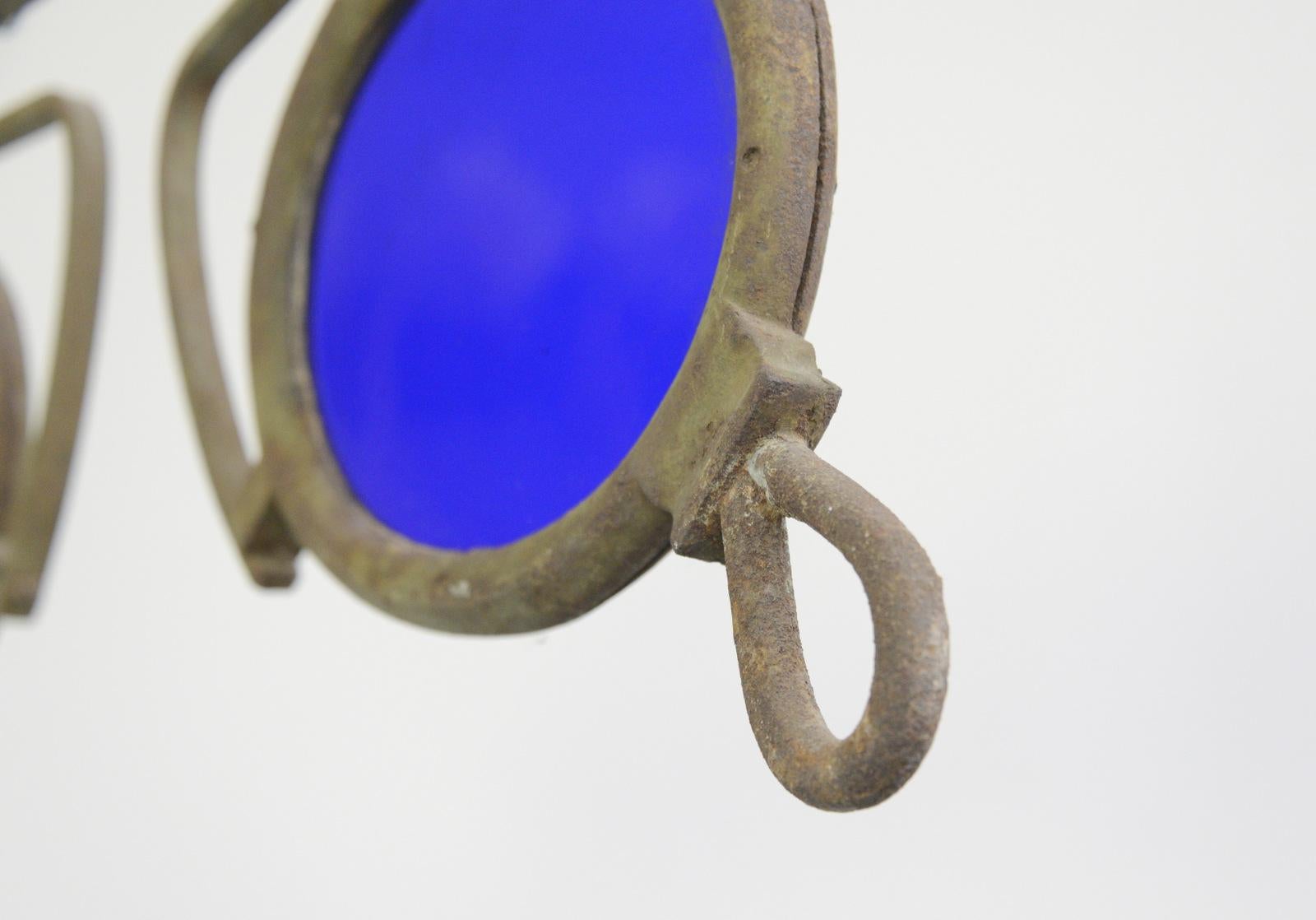 19th century German opticians trade sign

- Wrought iron frame
- Original hand blown cobalt blue glass
- German, 1890
- 78cm long x 3cm deep x 32cm tall

Condition report

Some patina to the iron surface and some bubbles in the glass, no