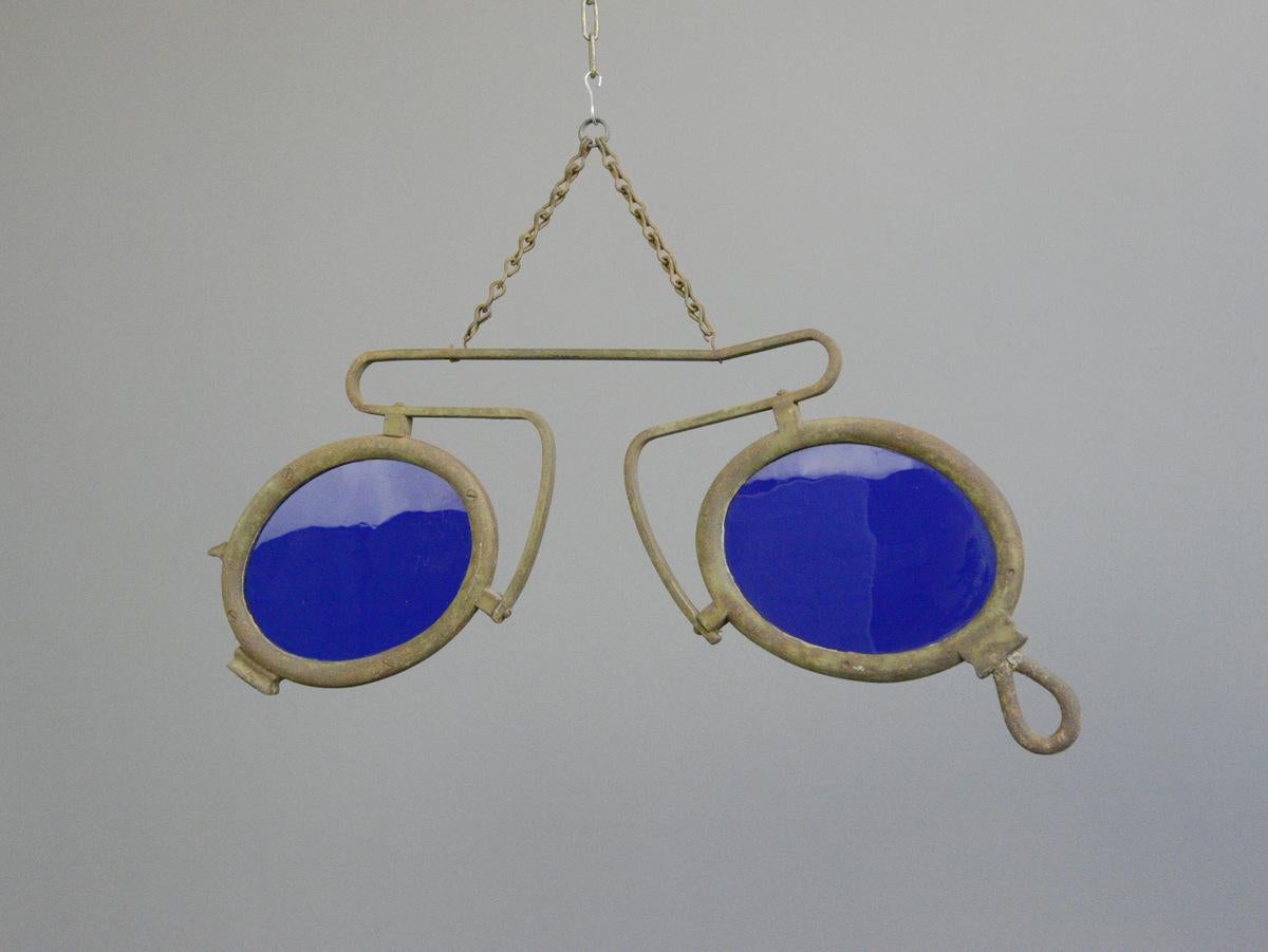 19th century German opticians trade sign

- Wrought iron frame
- Original hand blown cobalt blue glass
- German, 1890
- Measures: 78cm long x 3cm deep x 32cm tall

Condition report

Some patina to the iron surface and some bubbles in the