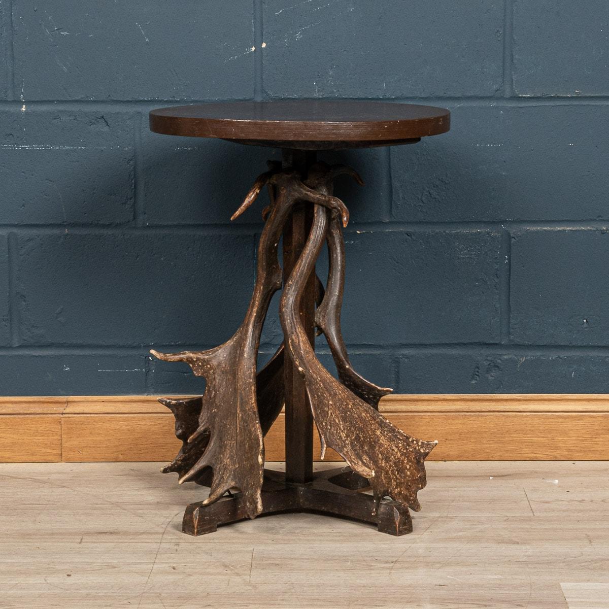 A rare Black Forest side table made in the Swiss-German borders around the latter part of the 19th century. The wood structure is flanked by a series of deer antlers arranged in a symmetrical way to give the little table a functional use whilst