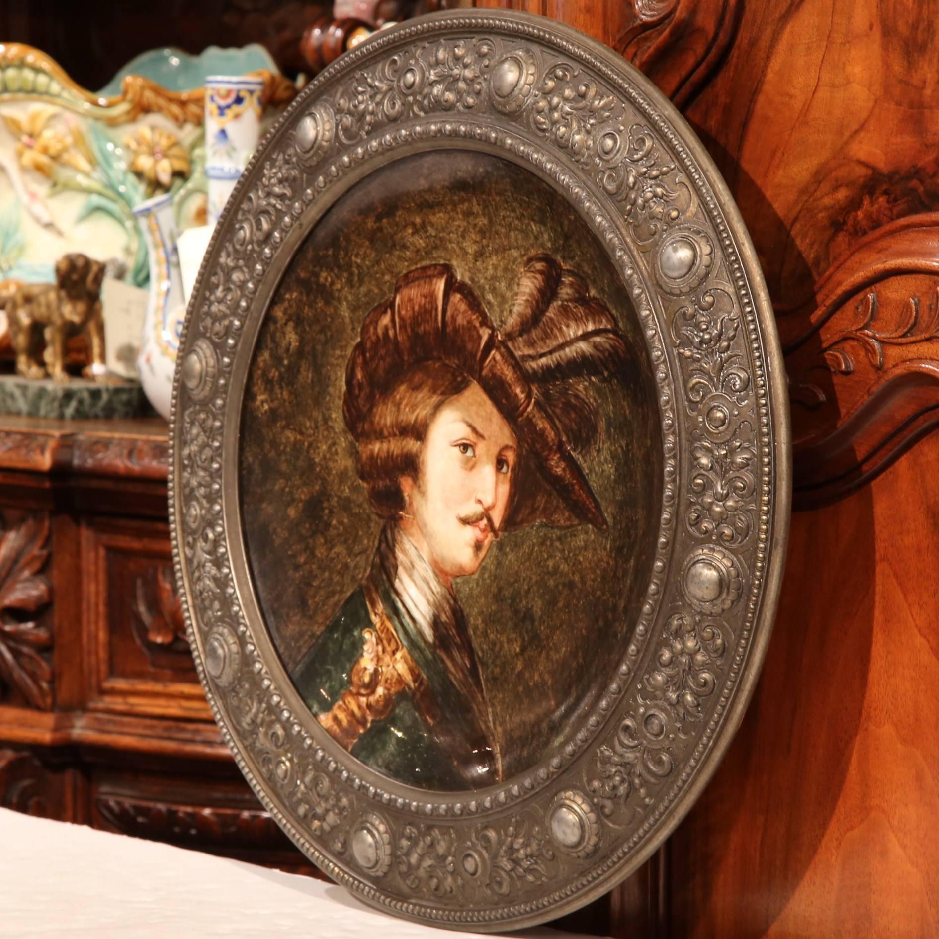 Decorate a man's office with this large, hand painted porcelain plate; crafted in Germany, circa 1880 and round in shape, the painted ceramic platter depicts the portrait of a man dressed in ornate period clothing. The antique wall plate is set in a