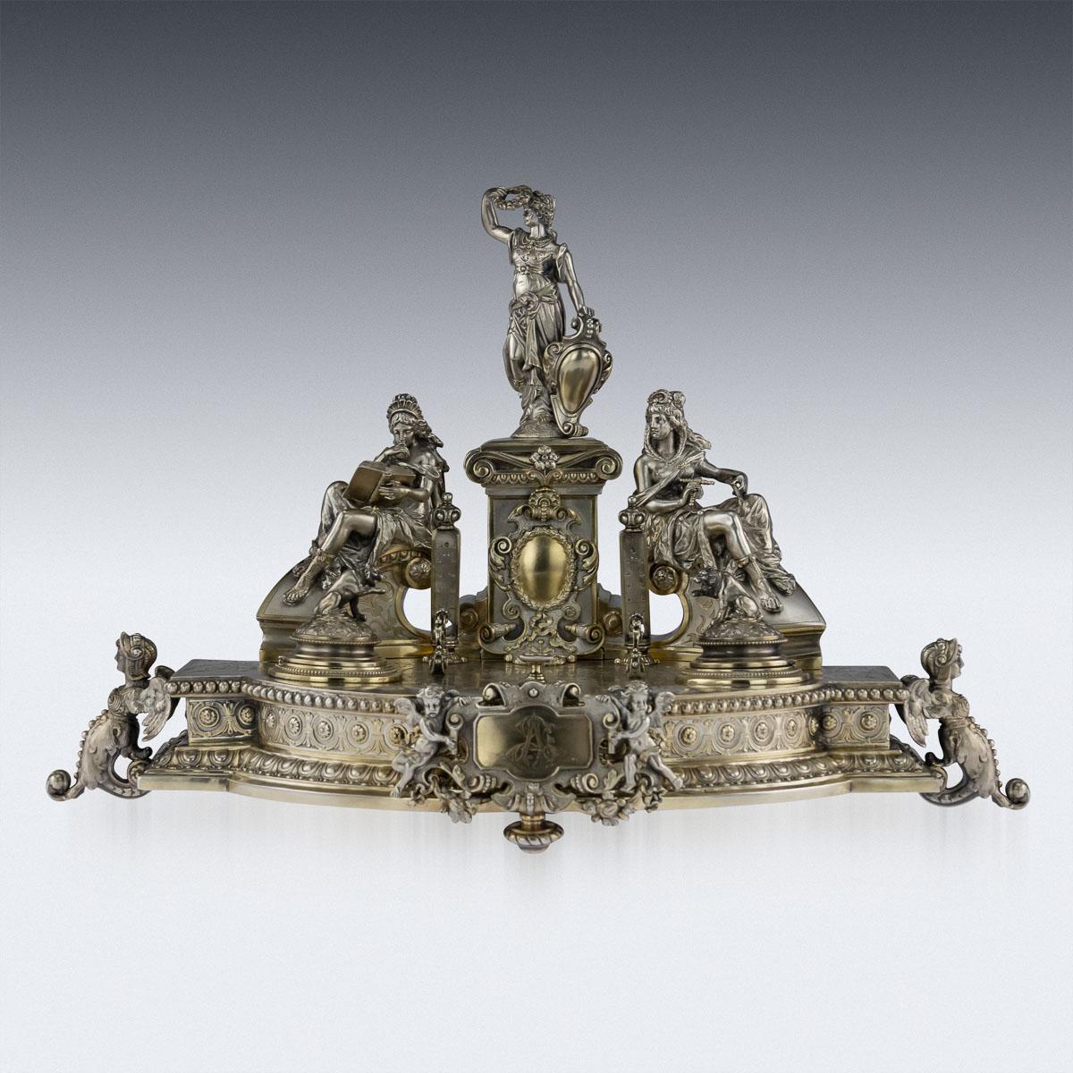Antique late 19th century German impressive silver-gilt desk stand, the shaped oval base on three plain stud feet and two winged demi-female figure feet, with foliage and rosette borders. This exceptional inkstand is fitted with a twist bell, two