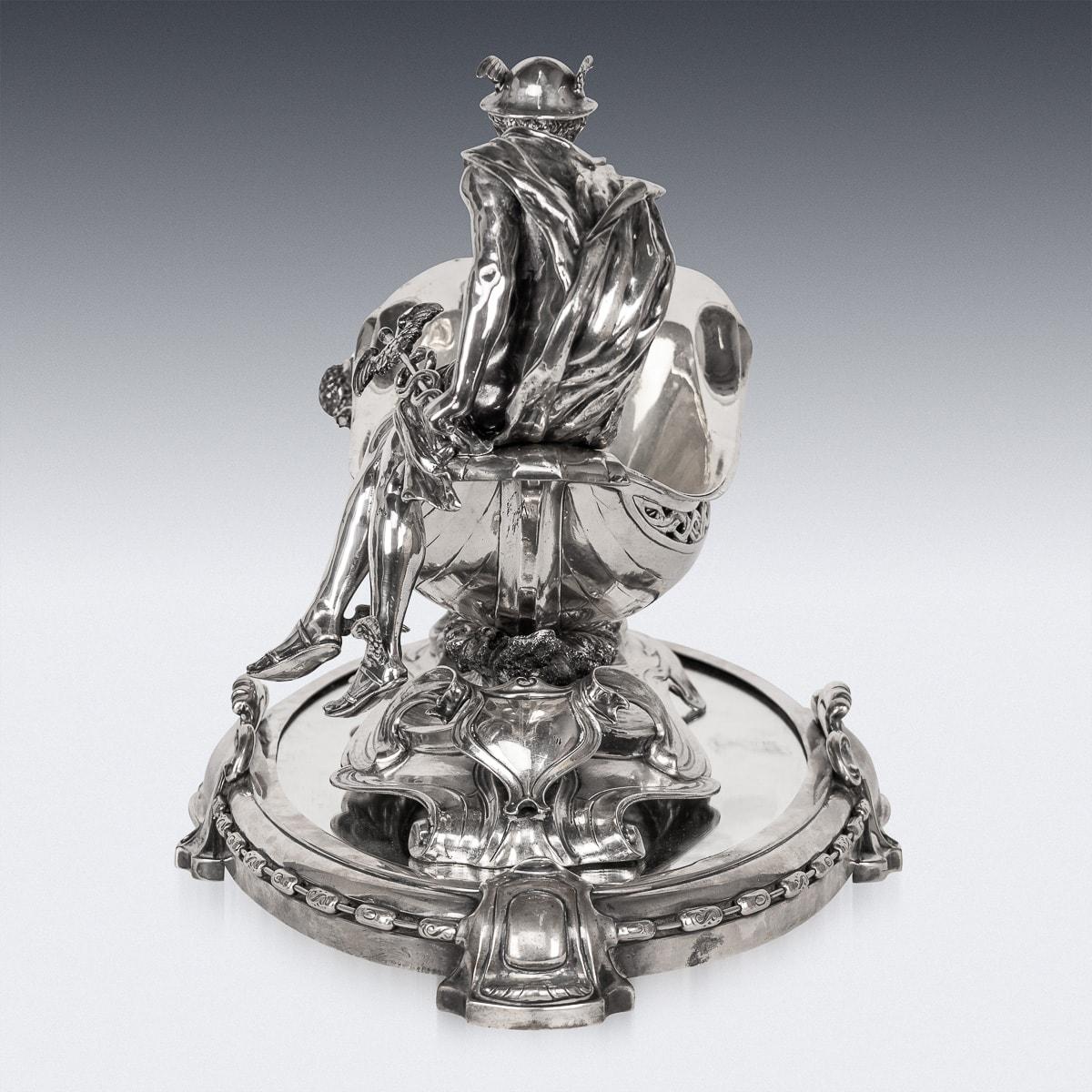 Antique 19th Century German large solid silver centrepiece, depicting the boat-form bowl raised on a scrolled base chased with waves, with a fully modelled figure of the god Mercury seated at the stern, the bow with the upper torso of a maiden