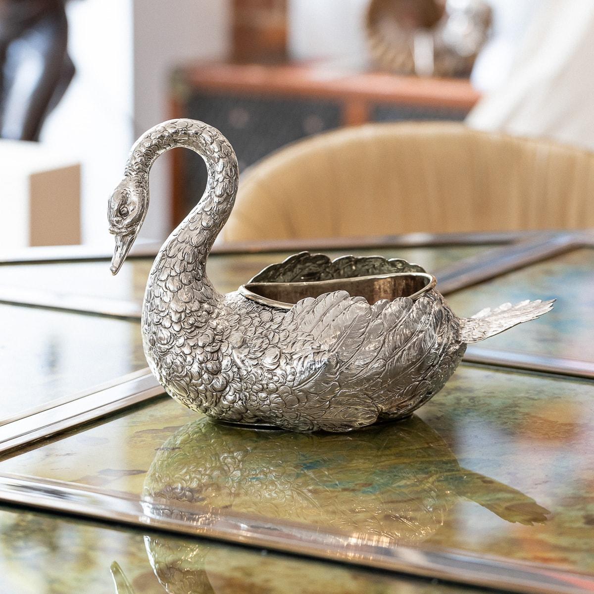 Antique late-19th Century German solid silver jardiniere, swan shaped, applied with a pair of hindged wings. The sides are chased with a feathers in relief, Inside fitted with a brass liner. Hallmarked German silver (800 standard), crowned R