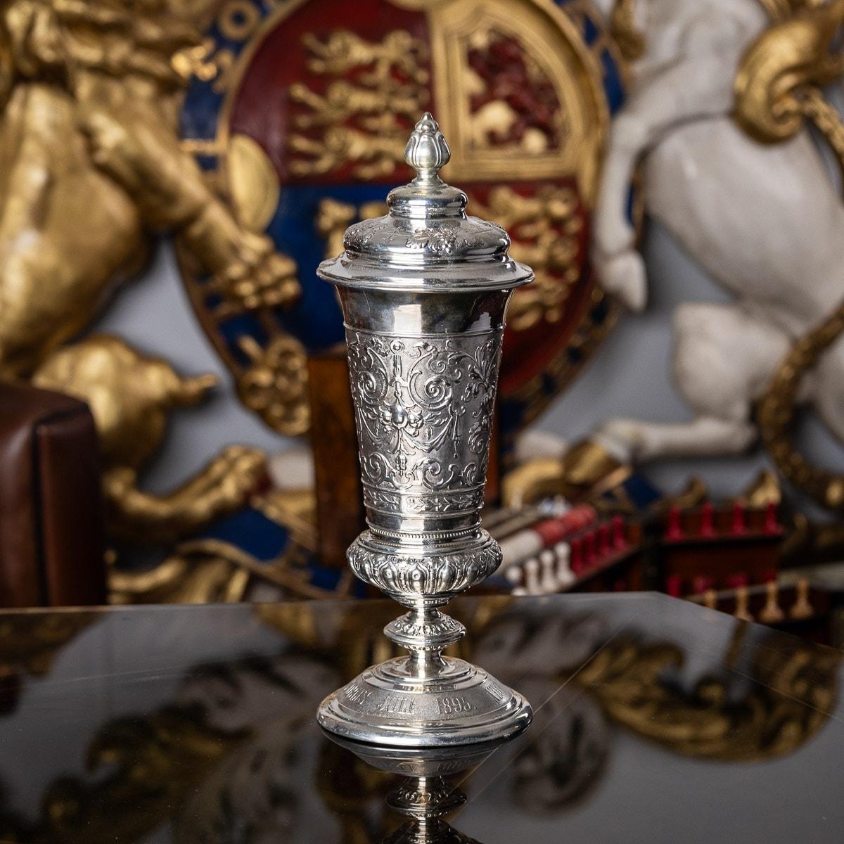 Antique late 19th Century German solid silver cup and cover, featuring stunning workmanship, made in the Renaissance style, it stands on a circular domed foot chased with a foliate decoration and grapevine bands to the lid, the body chased with a