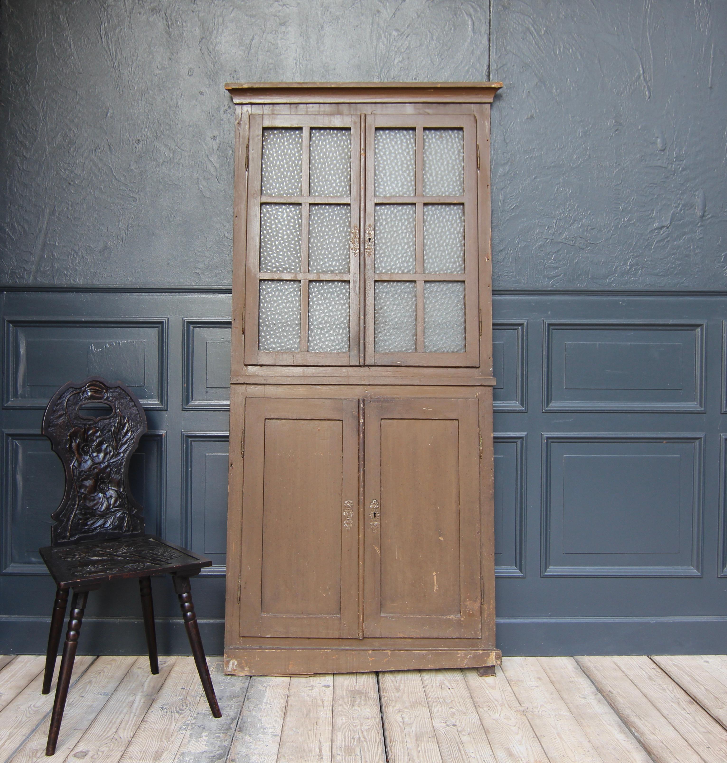 A 19th century German Front of a built-in wall cupboard in unrestored original condition.

High rectangular oak frame with 2 double doors hung on external hinges and moulded cornice. Lower doors made in frame and panelled construction. The upper