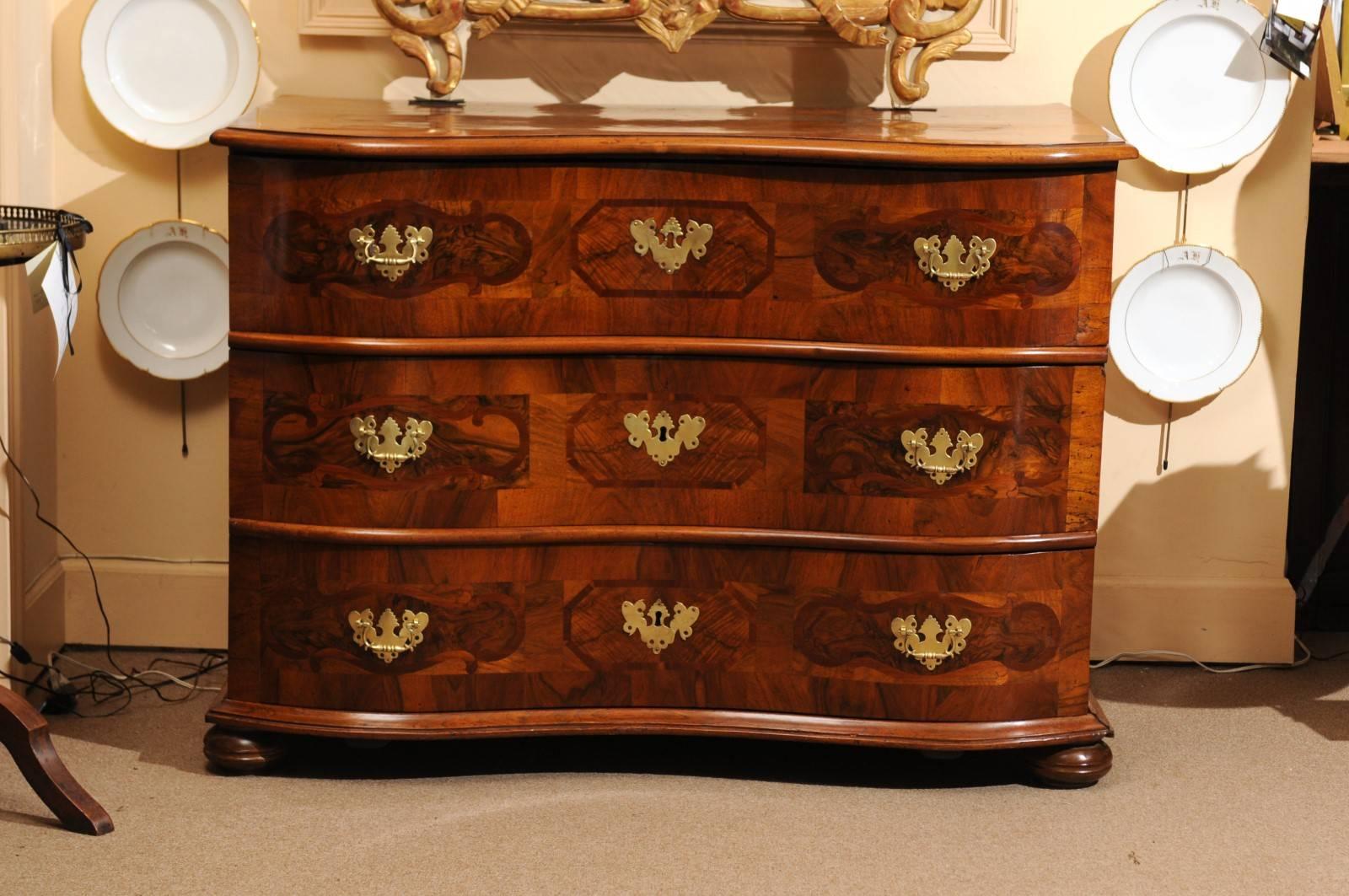 Parquetry inlaid walnut commode with serpentine shape, bun feet, and three (3) drawers, 19th century Germany.