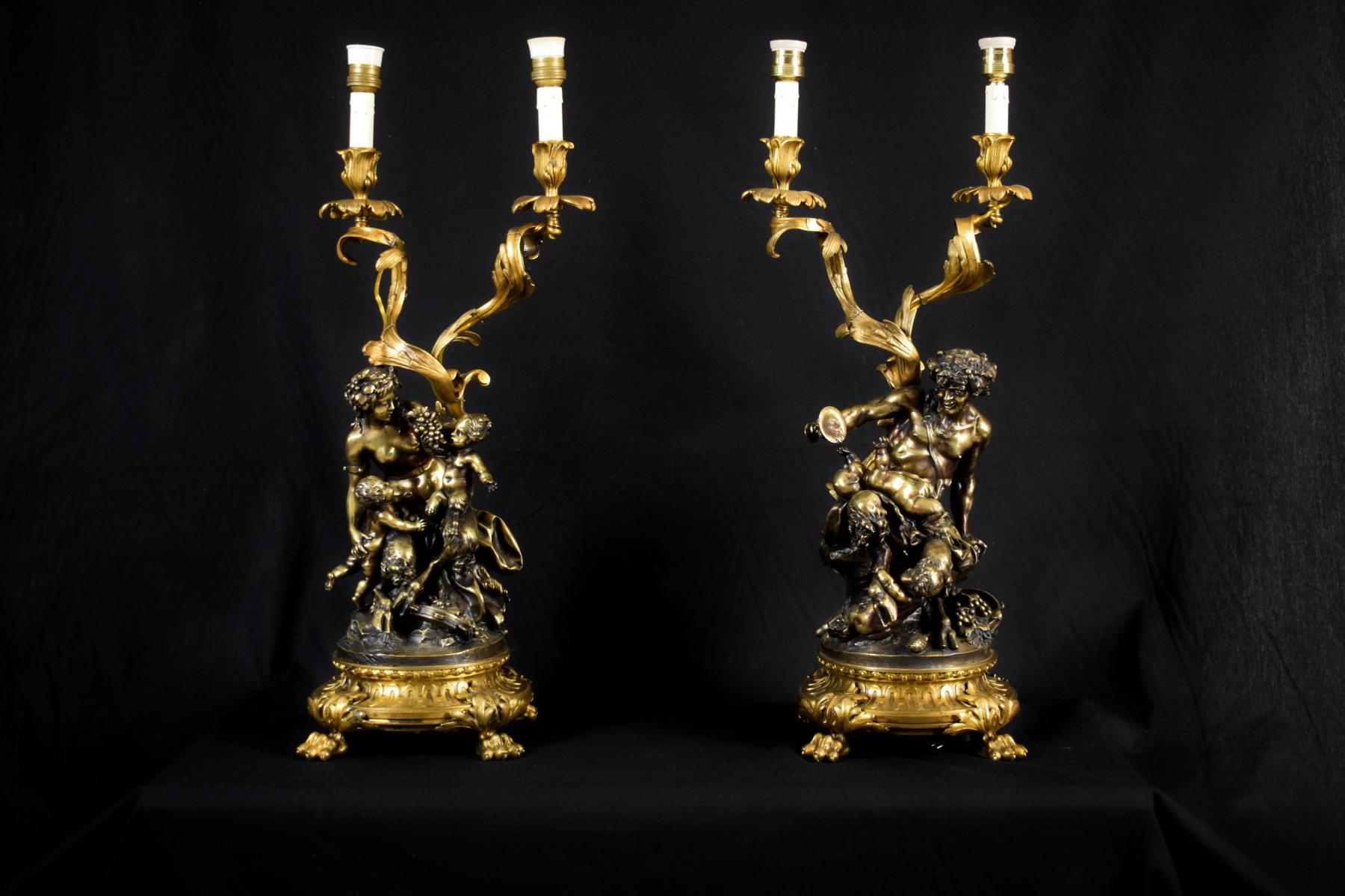 Pair of important candlesticks in gilt and patinated bronze, lamp mounted.
Depicting Bacchanal of Satyrs and Signed Clodion.
France 19th Century 
Measures h only candlesticks 65 x p 27 cm; h with lampshade 86 cm

This pair of important two lights