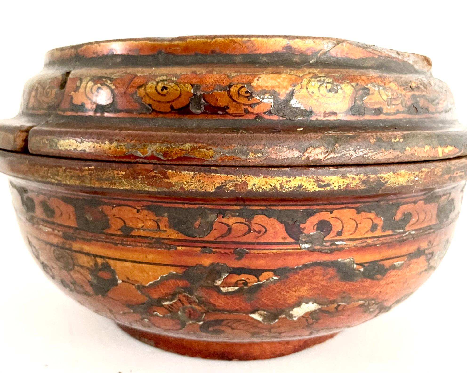 A beautiful late 19th century lacquer covered bowl that was once used for storing the famous Tibetan barley flour (Tsampa). This beautifully handcrafted wooden bowl has a gorgeous, layered patina. The bowl is hand painted with gold and black