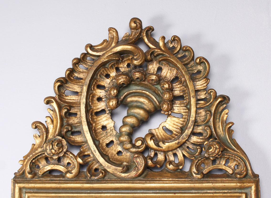 Gilded wall mirror

Germany
Wood, stucco
Baroque style around 1860

Dimensions: height 123 cm, width 59 cm

Magnificent mirror in baroque style from around 1860 with original faceted mirror glass.
The frame is carved from wood and gilded.