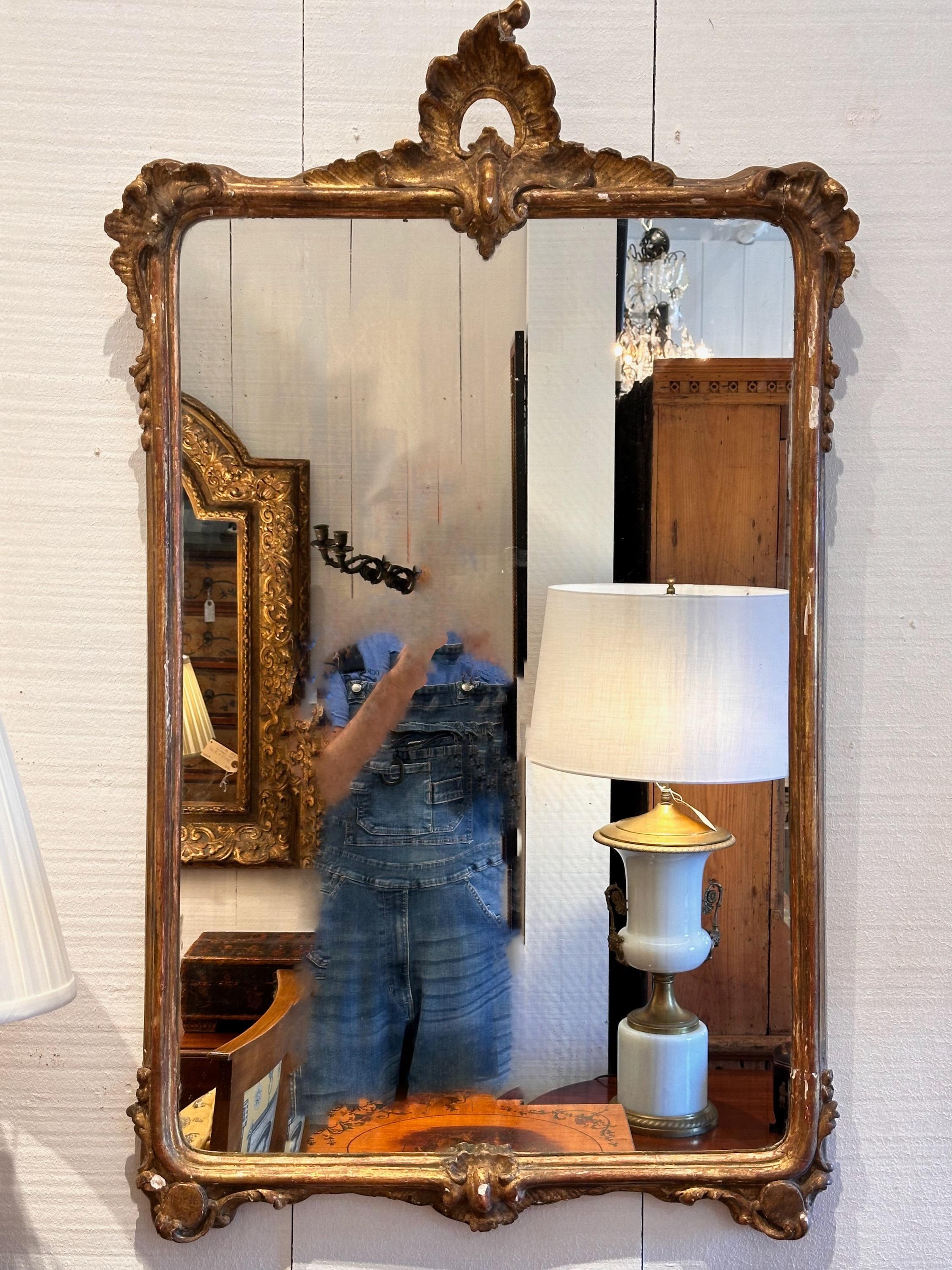 Looking pretty in this mirror is easy . Carved and gilded frame