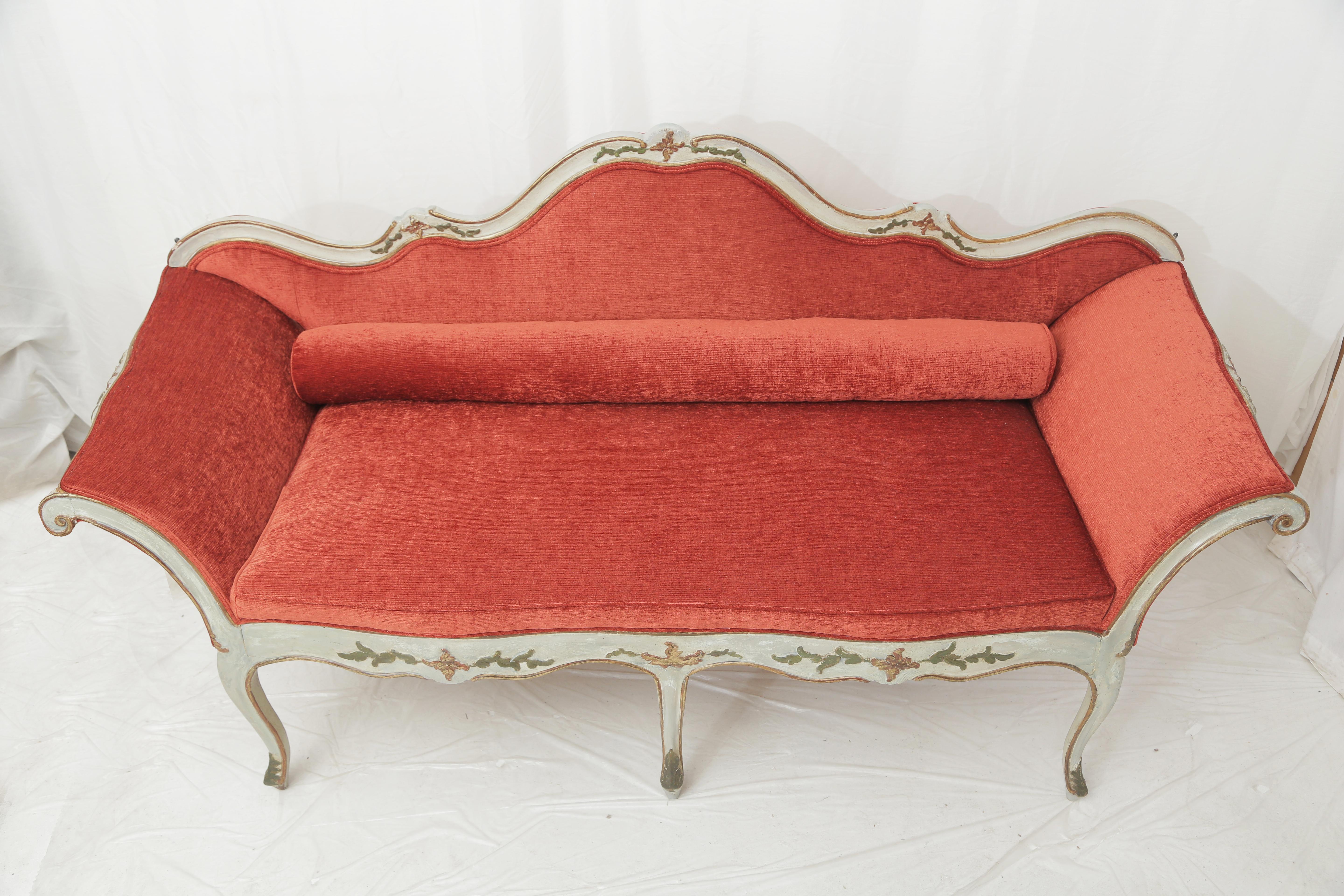 Italian sofa probably Piedmontese  painted with a light grey patina (original color) on a walnut frame.
Flowers and vegetal carvings all around the front part of the frame.
Entirely re-upholstered with a coral velvet fabric.
The paint of the frame