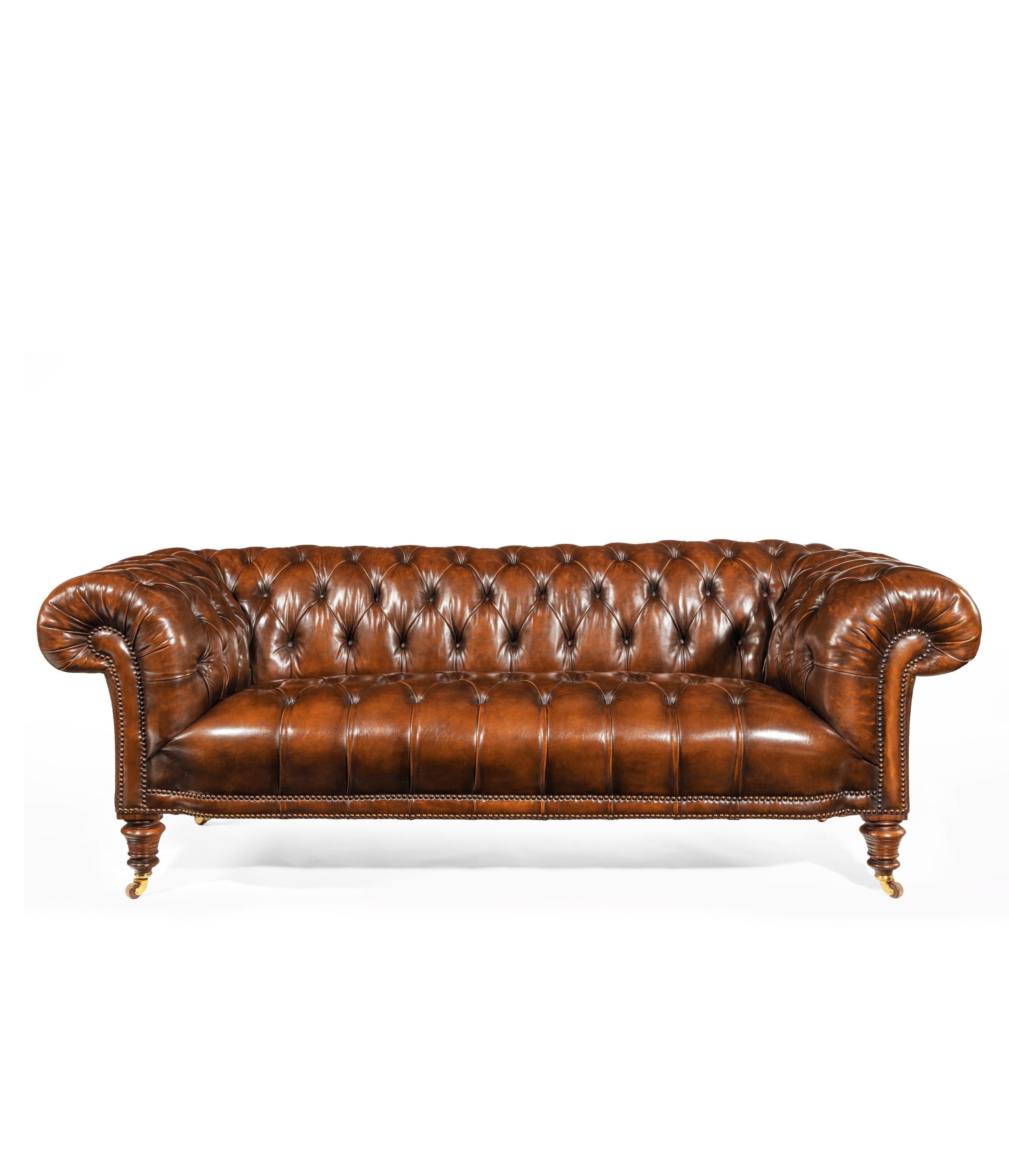 An extremely well drawn 19th century figured walnut deep buttoned leather upholstered Chesterfield by Gillows, the back legs stamped 5359 which is a four figured Gillows numbering stamp.

Having beautifully pronounced shaped scrolling arms and