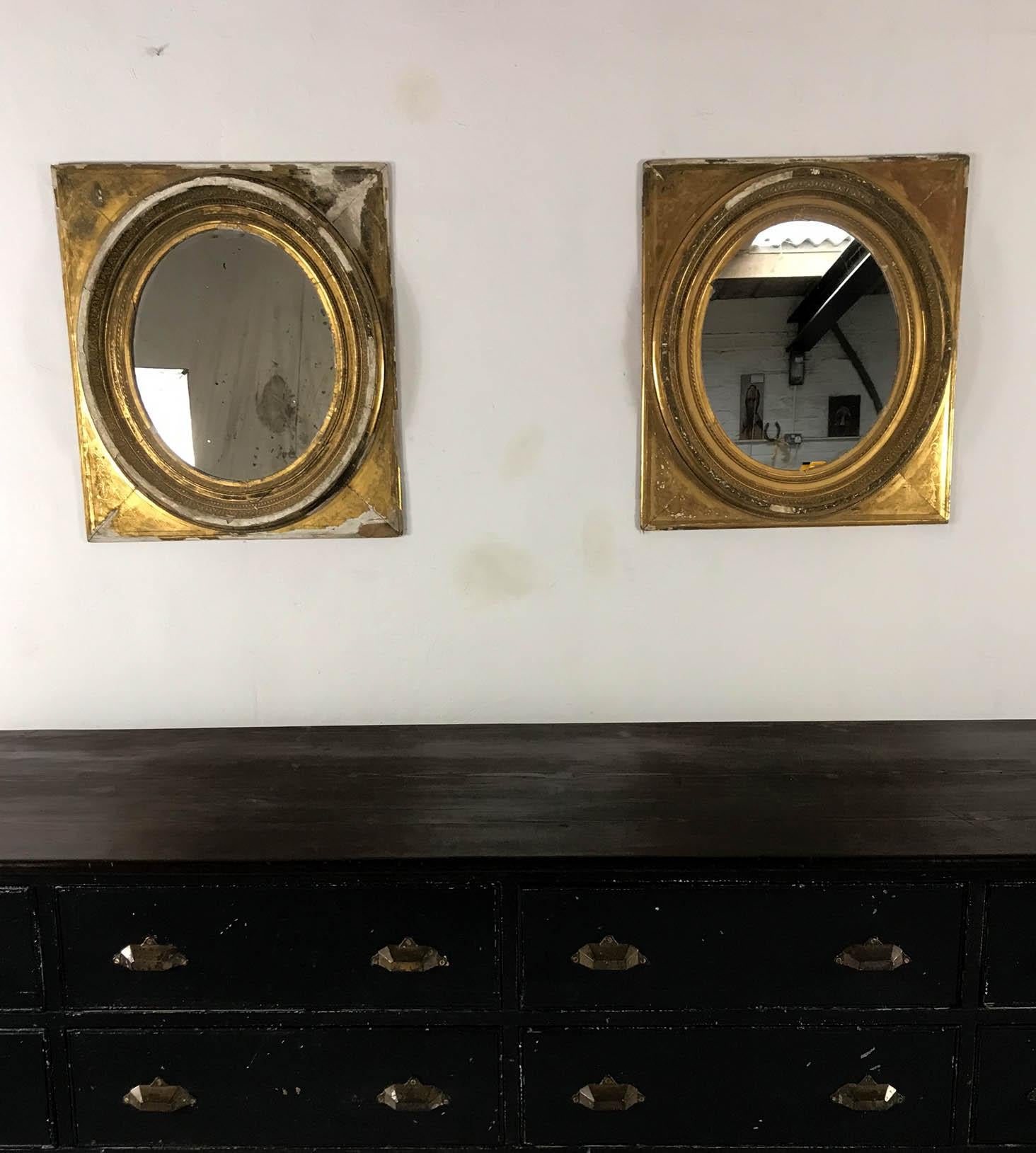 Pair of of French mirrors inside an oval and rectangular gesso and gilt frame. One is in better condition with some loss to the frame and the other is distressed but has an enviable rustic style.
The are available to buy as a pair or