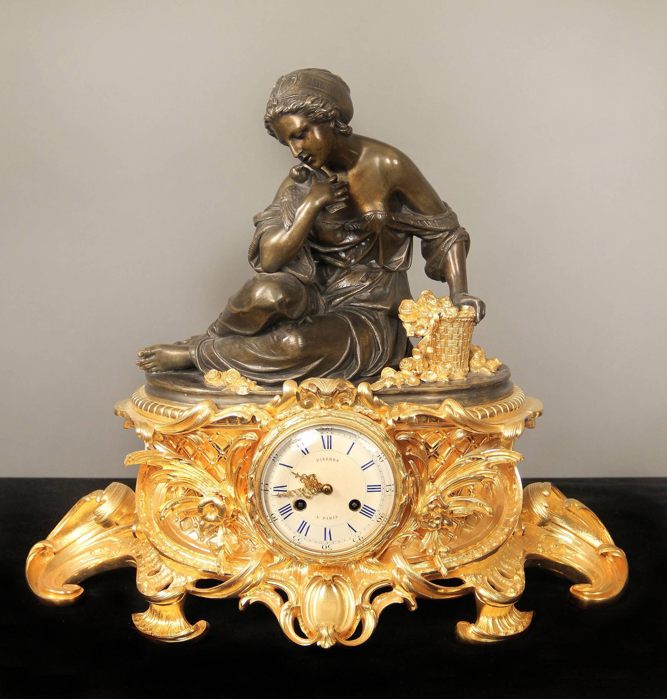 A fine mid-19th century gilt and patinated bronze three-piece clock set

By Victor Pierret

The figural clock of a woman and a bird seated next to a basket of roses above a gilded base designed with flowers. The candelabra with cherubs holding