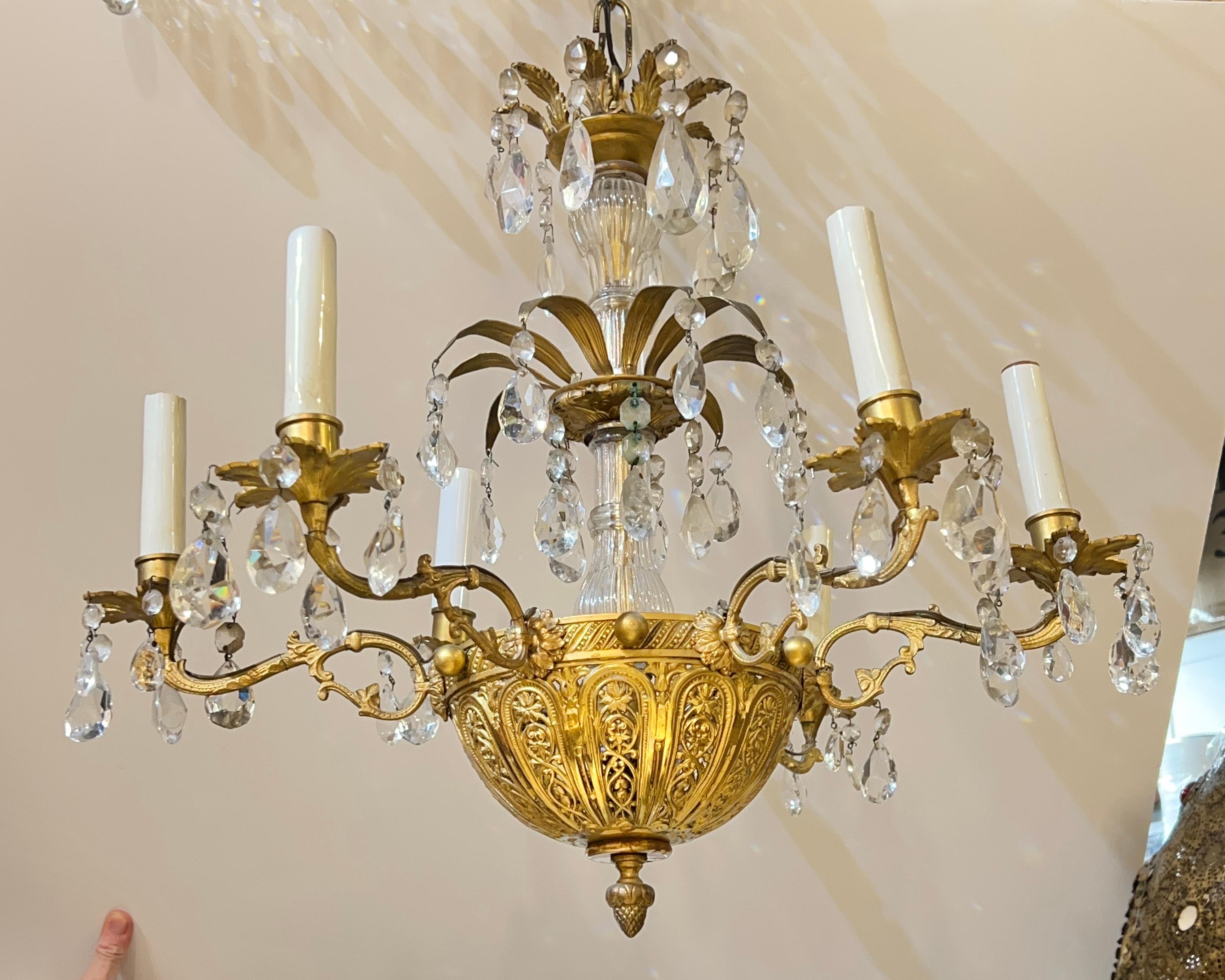 Antique (late 19th century) six light chandelier in the neoclassical style crafted from gilt bronze and crystal glass, electrified with candelabra size sockets and wiring, ready for use.