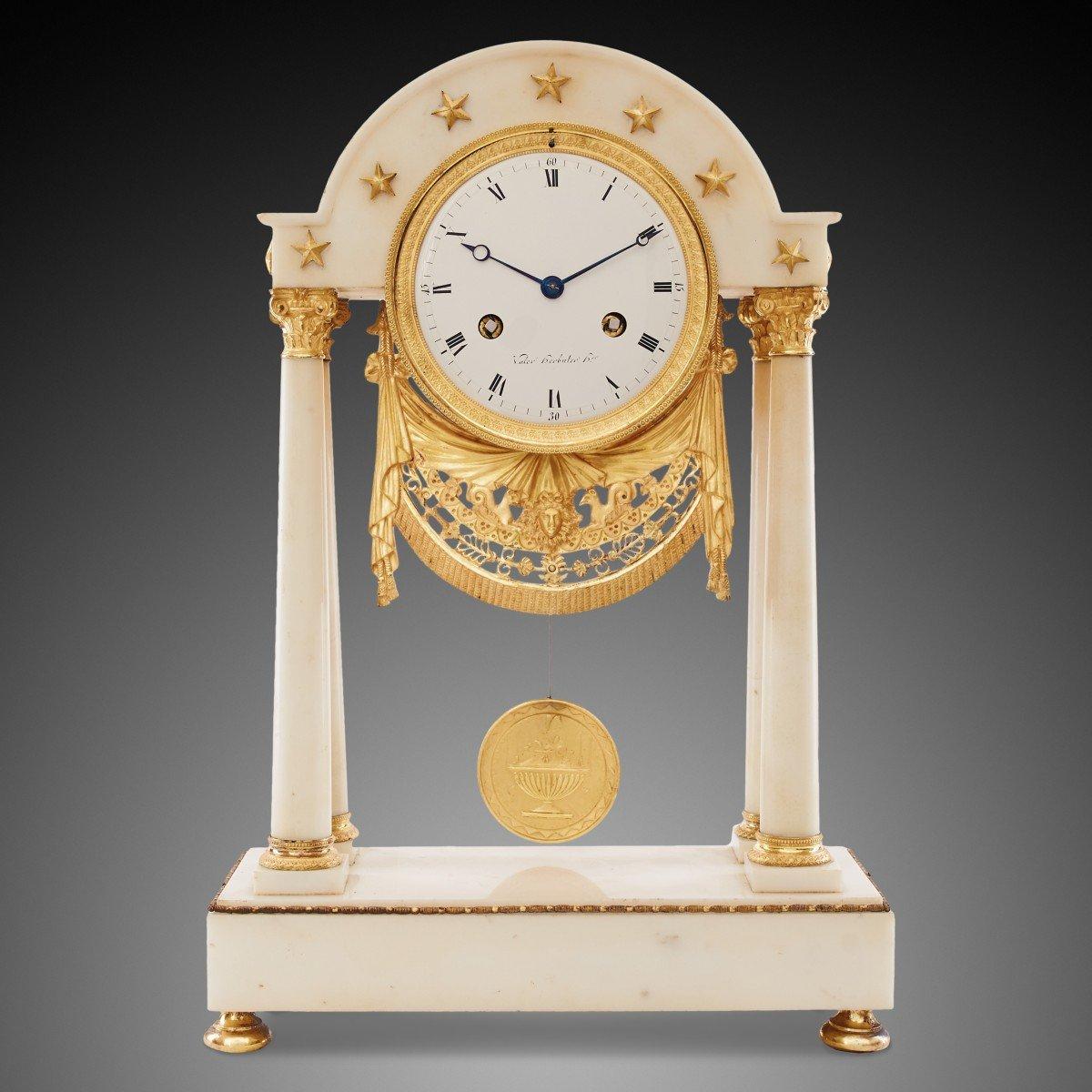 This striking mantel clock is a true testament to the exquisite craftsmanship and refined aesthetic of the Empire period in 19th-century France. The clock showcases a harmonious blend of form and function, typical of the style, with a strong