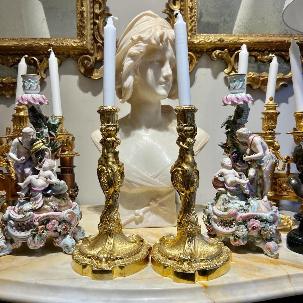 We present you with this wonderful and extremely rare pair of candleholders from the late 19th century Napoleon III era, embodying the exceptionally ornamental and dramatic Rococo style of Louis XV. Inspired by a model made by a great French