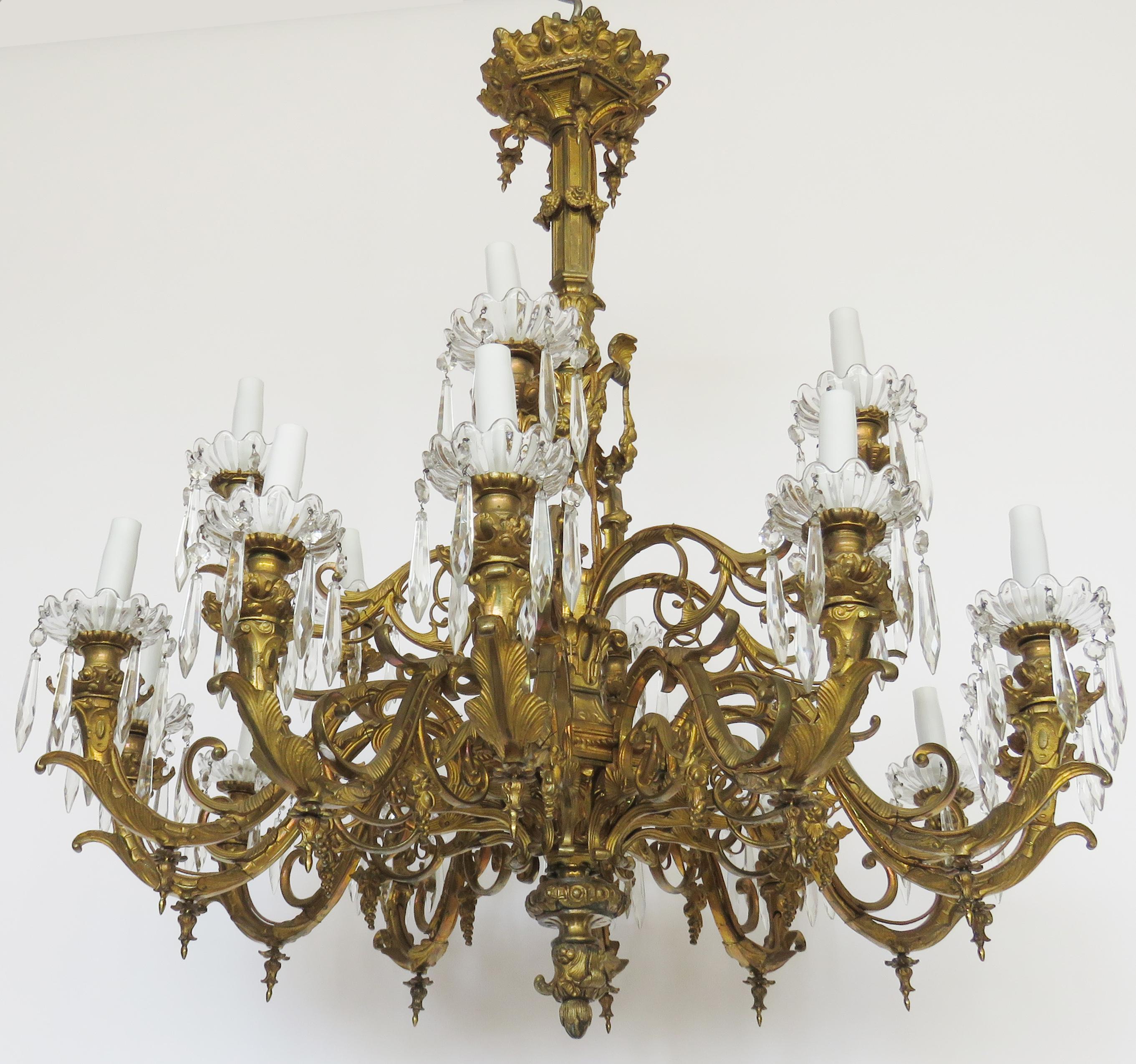Gilt bronze chandelier, extensively decorated with scrolls and acanthus foliage, two-tier candle arms, lower 12 lights, upper 6 lights.