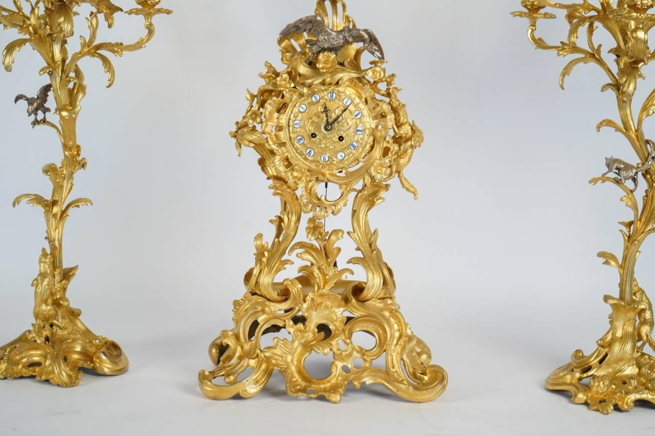 Gilt bronze clock set composed of pair of ten lights candelabras and clock.
style louis XV, rococo style.
Foliage, flowers and animals decors that descibes Fables of 