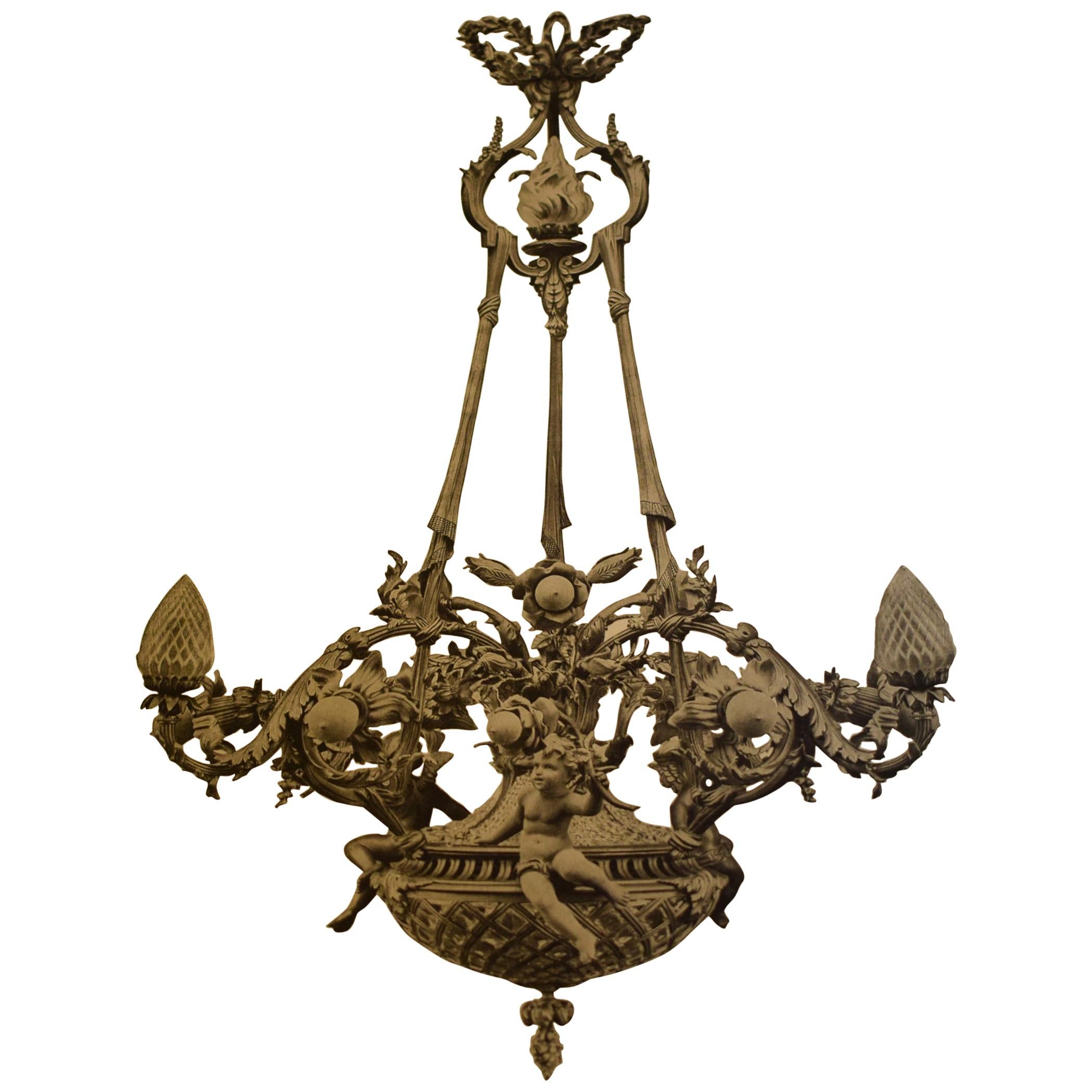A magnificent gilt bronze, crystal and frosted glass chandelier depicting putti. Exquisite detail. France, circa 1900. A picture of the original catalog is also shown (pg 224).
15 total lights: 12 exterior plus 3 inside the dome
Dimensions: Height