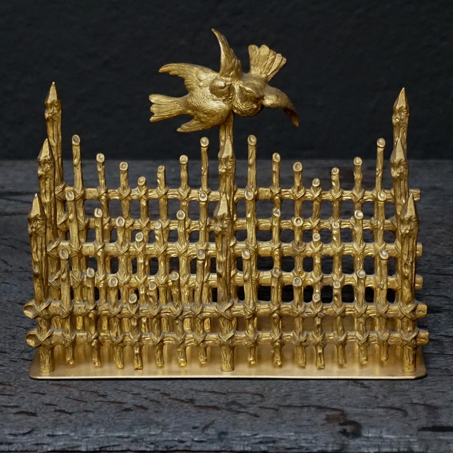 Victorian romantic and very charming bronze doré French letter holder with cast bronze dividers in the shape of three picket fences with love birds on the last fence on a flat brass base.

To hold all your 