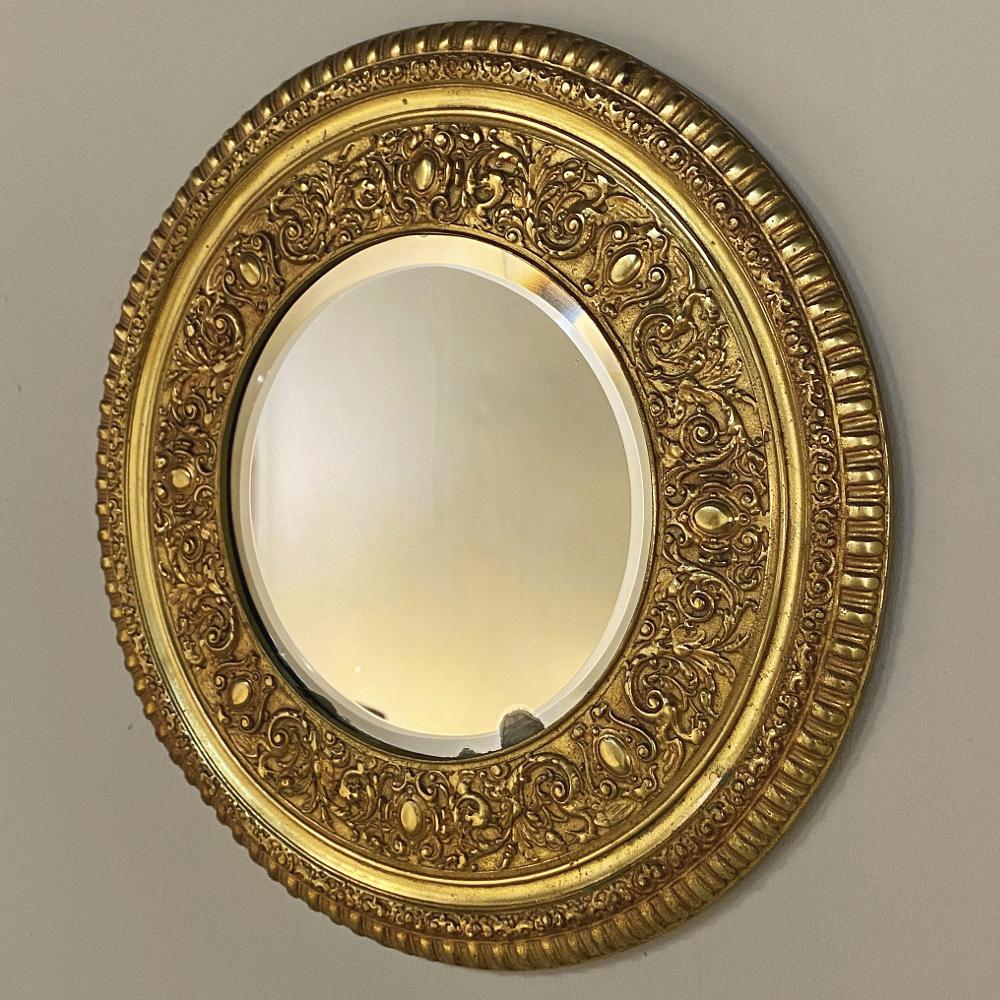 19th century gilt bronze mirrored plateau is a marvel of the Napoleon III period, and reflects the opulence of the age with elaborate and intricate embossing in a variety of nature-inspired motifs with heraldic crests strategically interspersed into