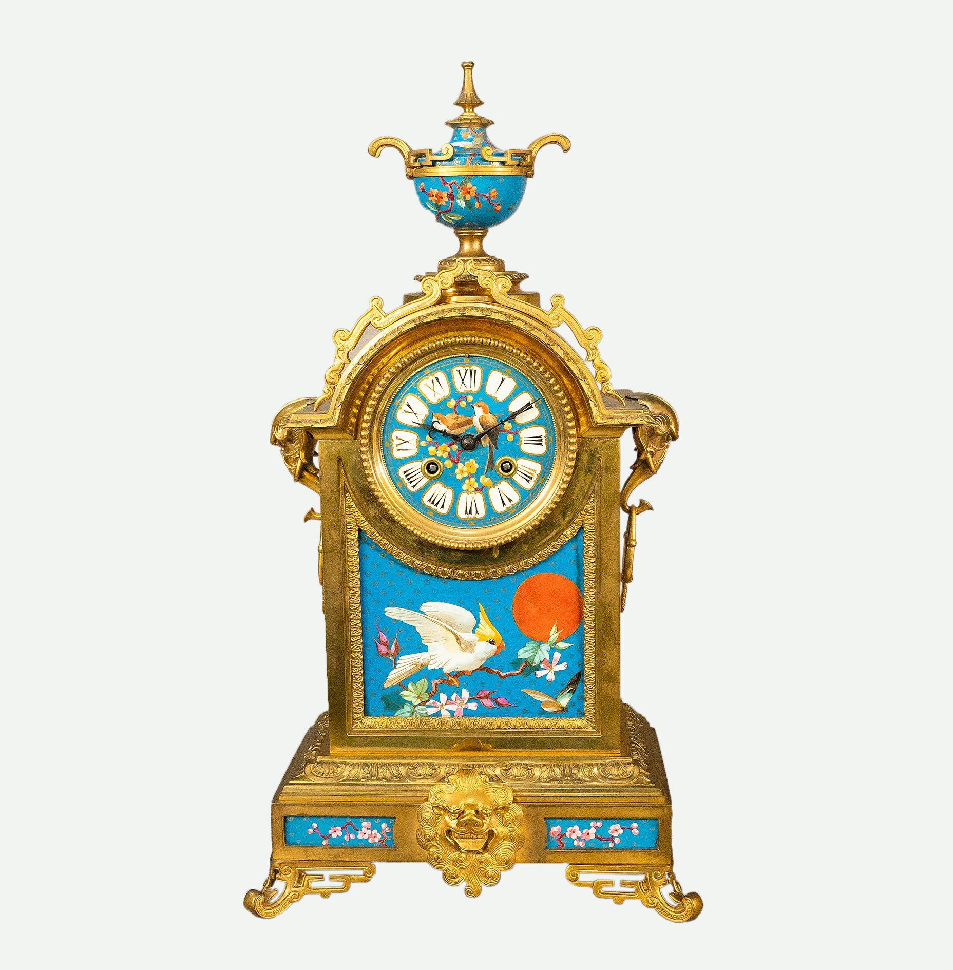 A very fine antique 19th century French gilt bronze and hand painted porcelain 3-piece clock set in the Japonisme style. The clock finely decorated with porcelain plaques, painted in the Japanese style with Cherry blossom branches. The front plaque