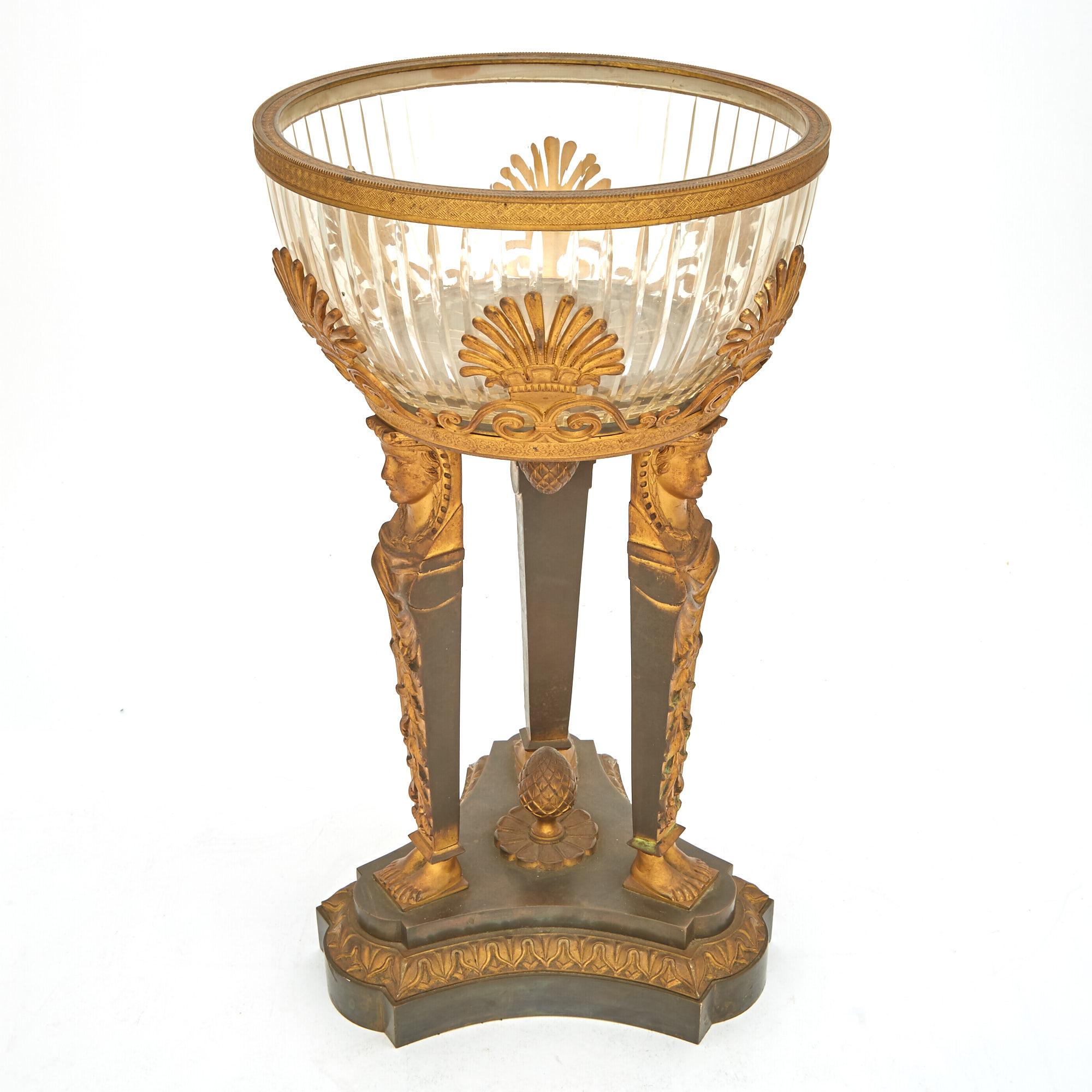 Step into the splendor of the 19th century with this exceptional Empire-style tableware centerpiece, a captivating union of gilt bronze mounts and cut glass that epitomizes the opulence of the era. At its heart lies a removable circular cut glass