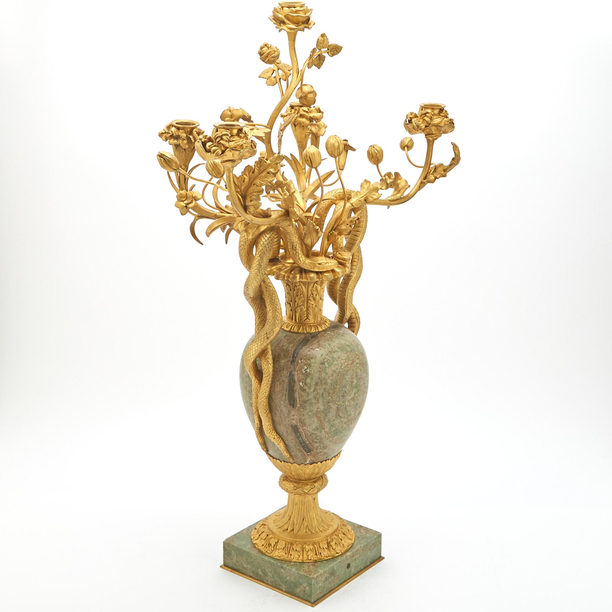 Illuminate your space with the timeless elegance of this 19th-century Louis XVI style candelabra, a true testament to refined craftsmanship and exquisite design. This five-arm masterpiece is adorned with lavish gilt bronze mounts that showcase